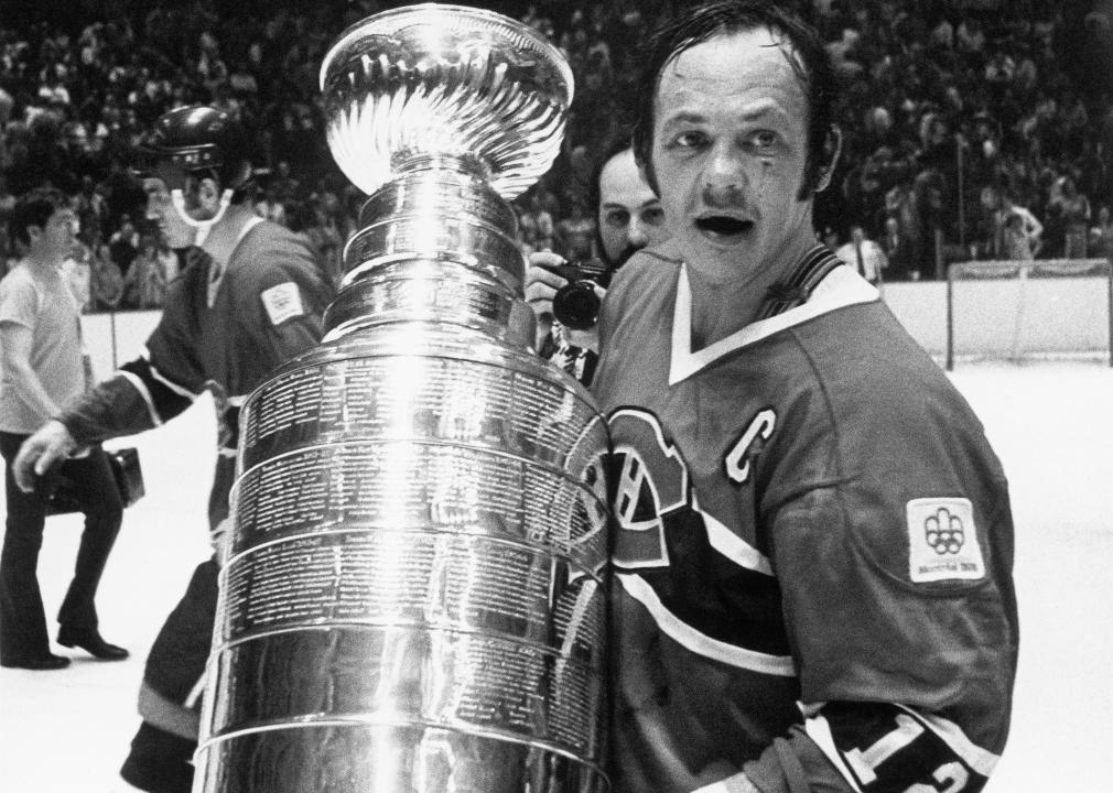 Yvan Cournoyer poses for a photo with the Stanley Cup Trophy