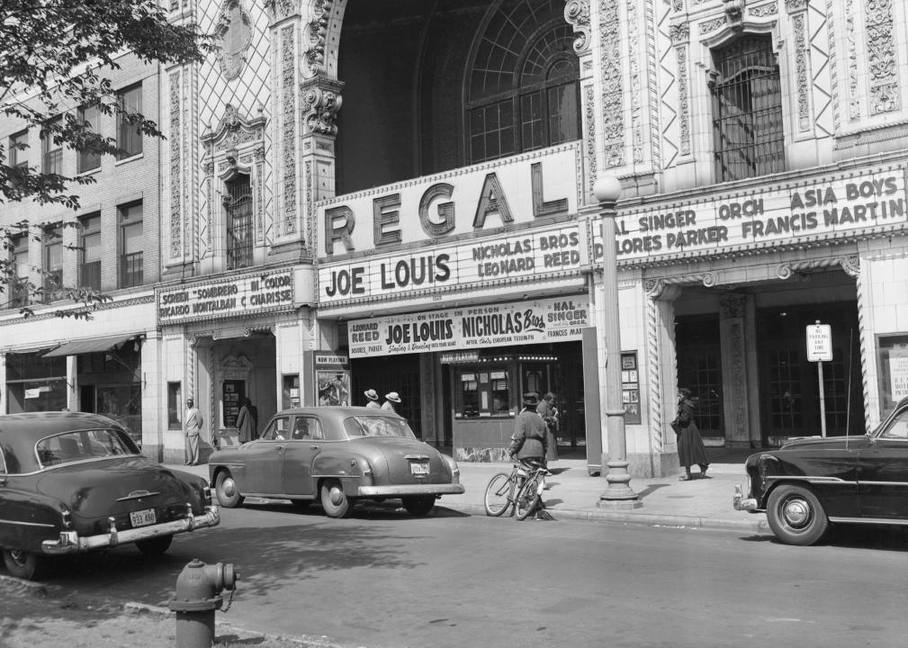 Car and show signs posted outside of the Regal Theater