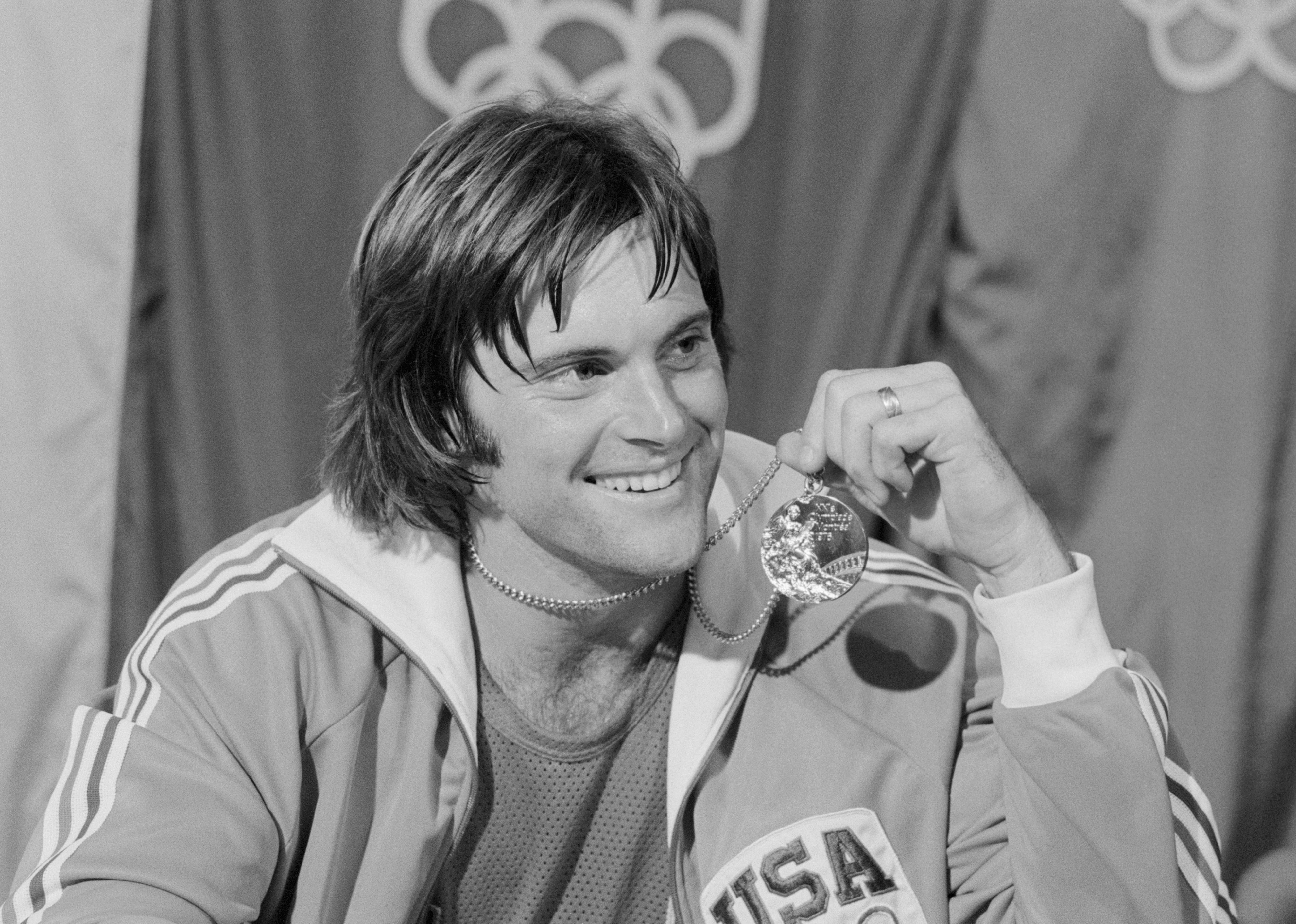 Caitlyn Jenner displays the gold medal won in the Olympic decathlon.