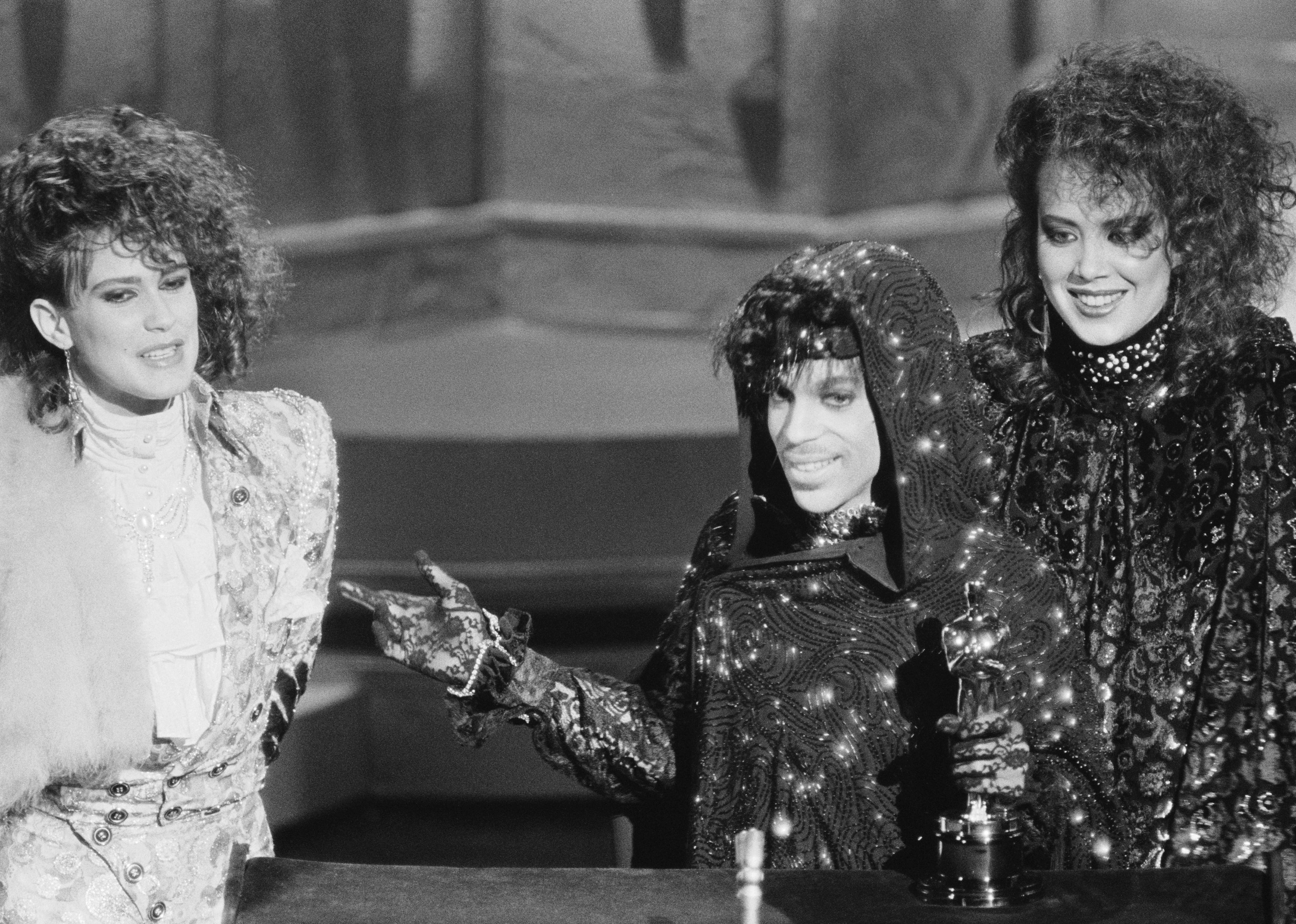 Prince and members of his group accept their Oscar for Best Original Song Score for 