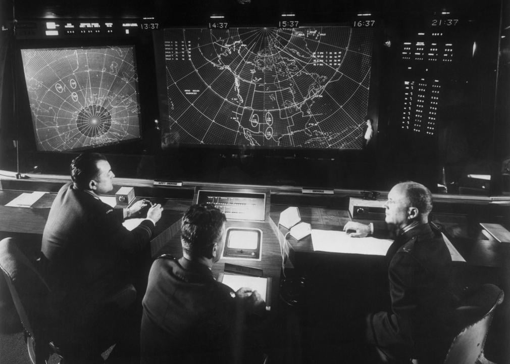 Men sit below radar at NORAD headquarters.