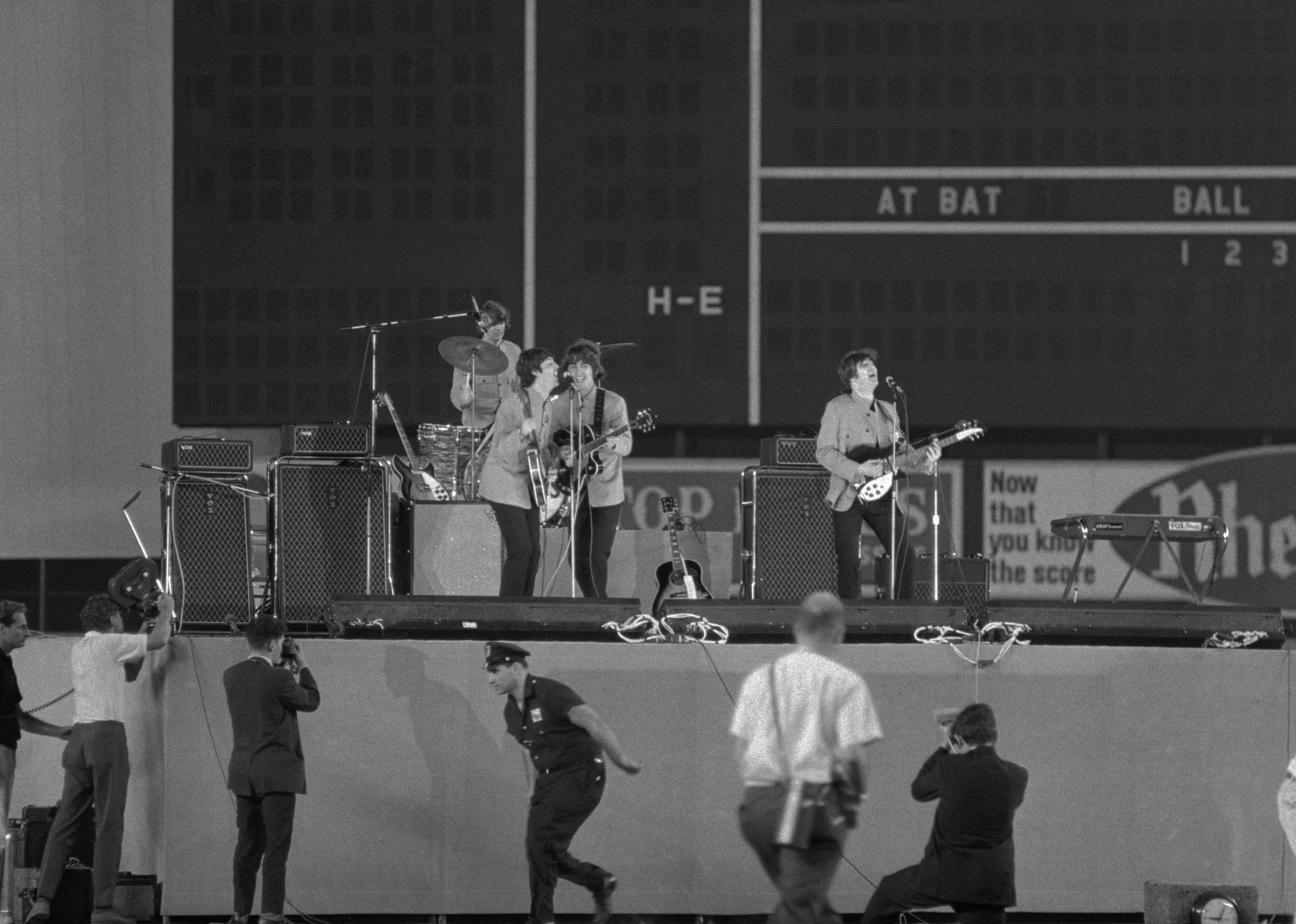 The Beatles perform for an audience of 55,000 people during a concert in Shea Stadium.