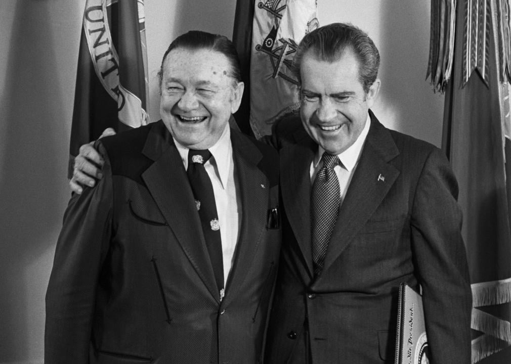 Richard Nixon embraces country music entertainer Tex Ritter at the White House.