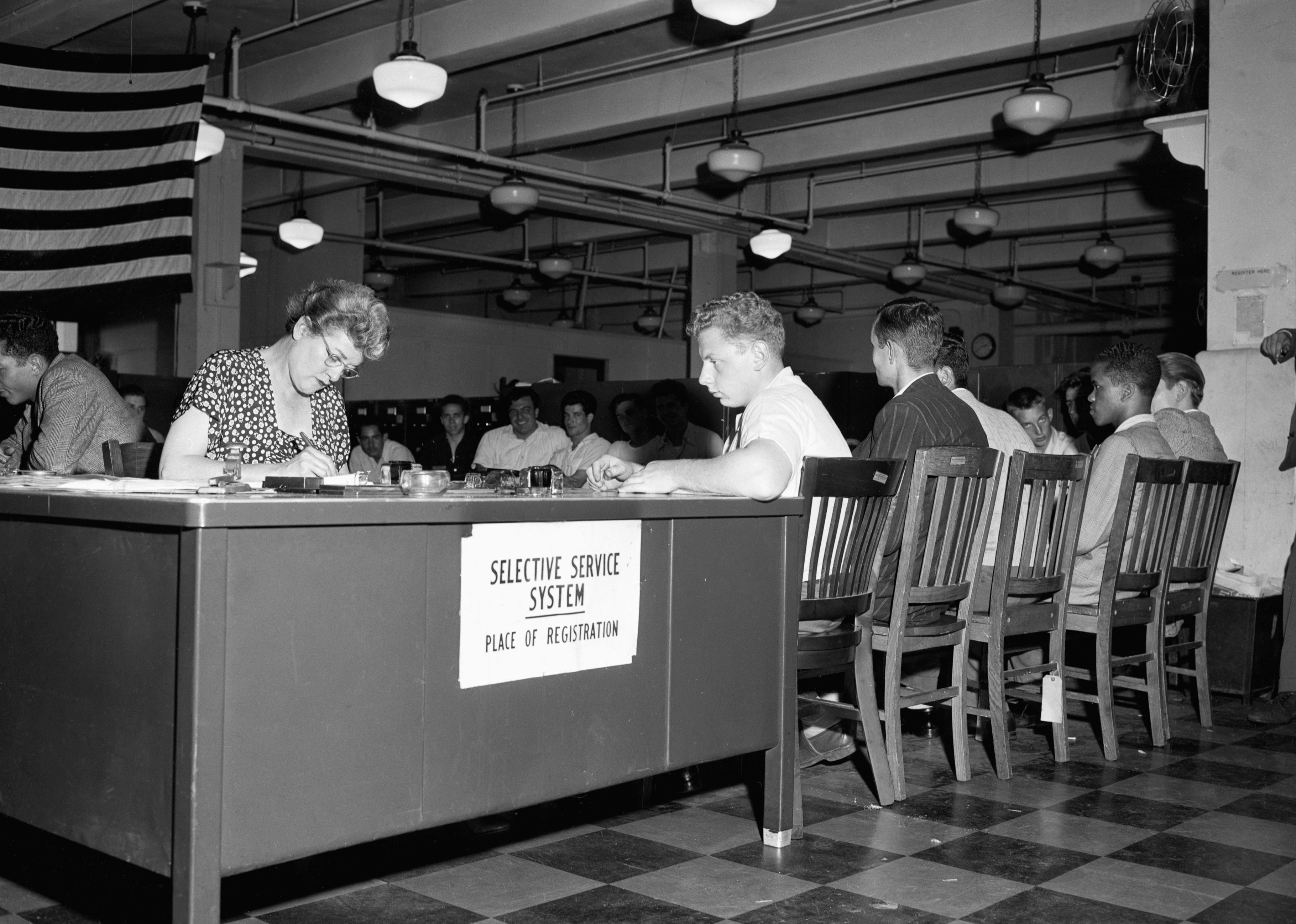 New York City Youths Wait seated to register for draft at 80 Lafayette Street.