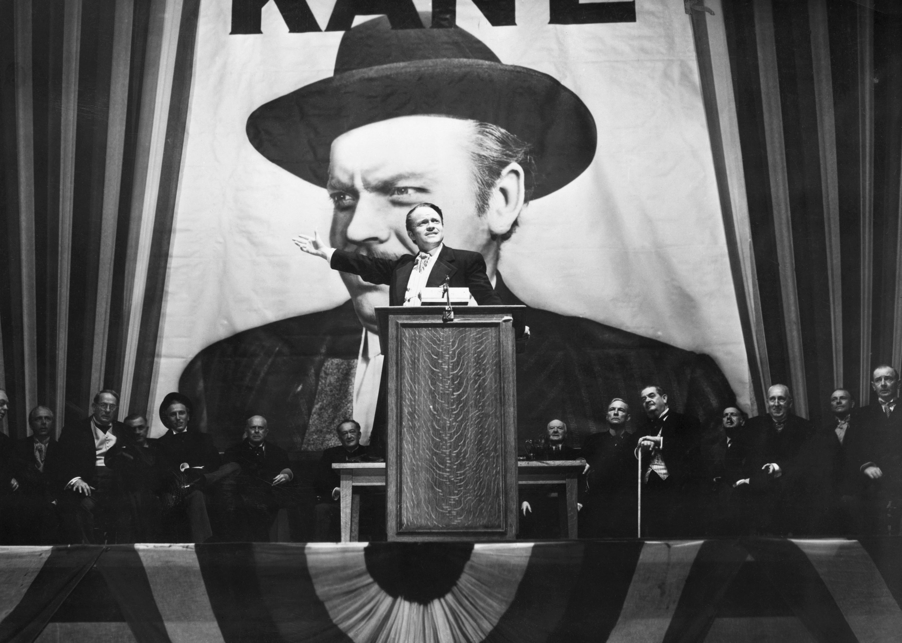 Orson Welles makes a speech before a portrait of himself in a scene from Citizen Kane.