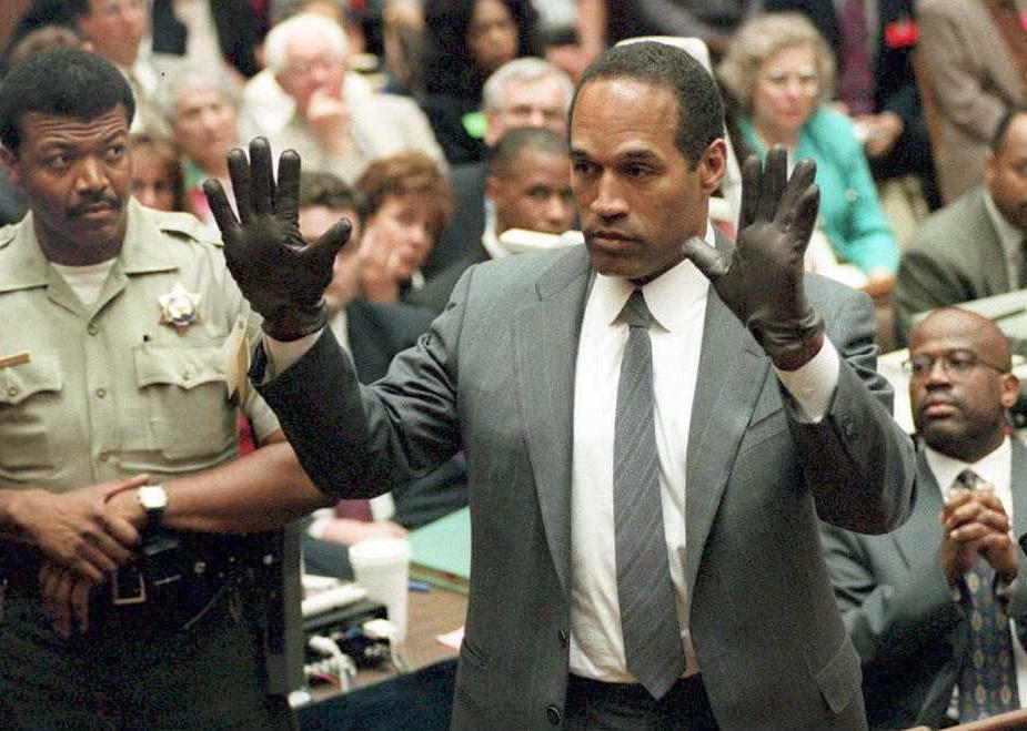 O.J. Simpson shows the jury a new pair of Aris extra-large gloves.