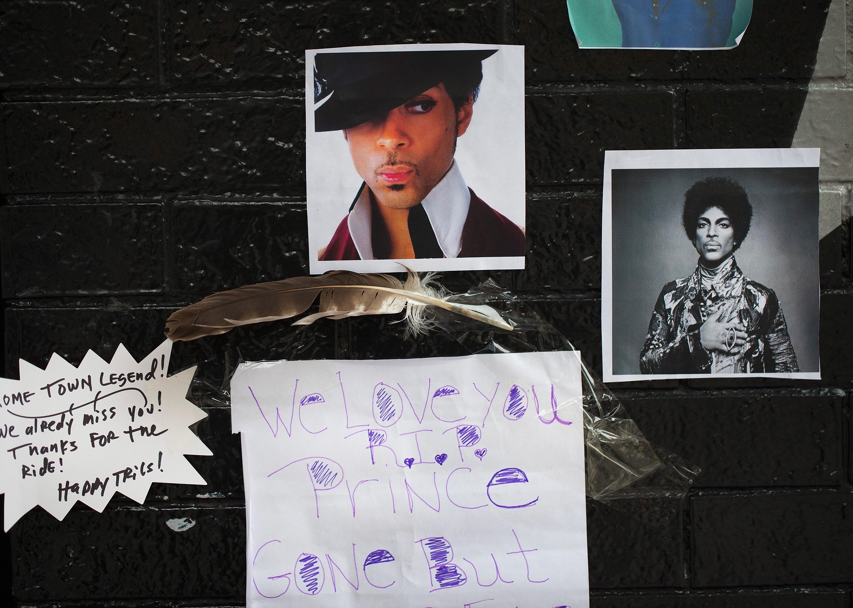 Photos of Prince on the wall outside of the First Avenue nightclub where fans created a memorial.
