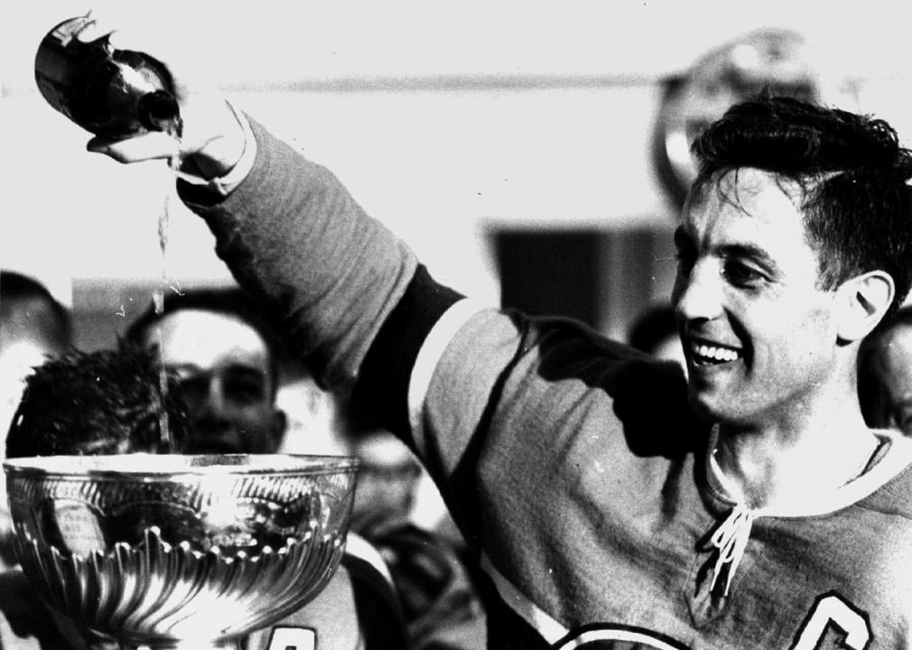 Jean Beliveau pours champagne into the Stanley Cup Trophy