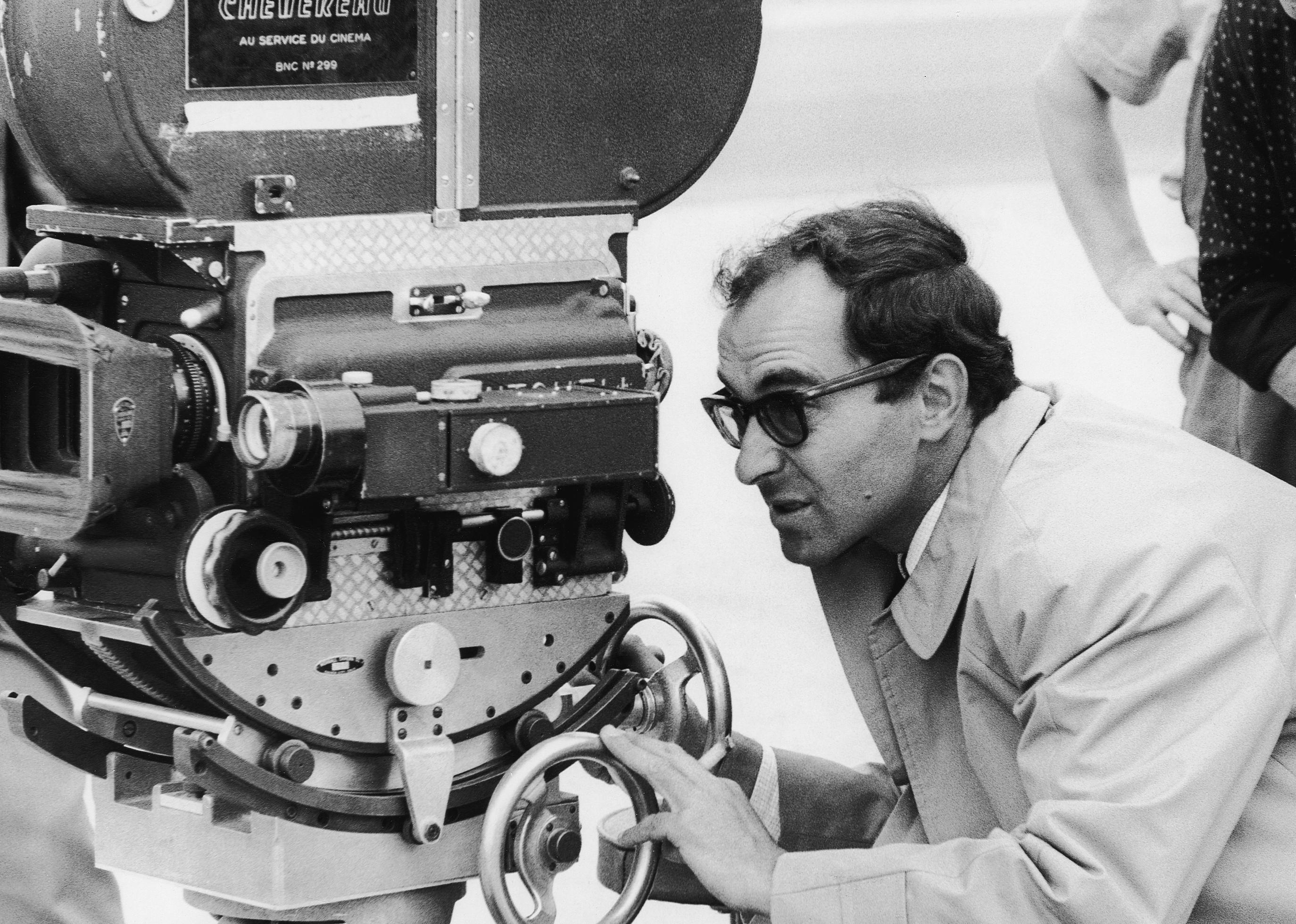 Jean-Luc Godard looking into a camera.