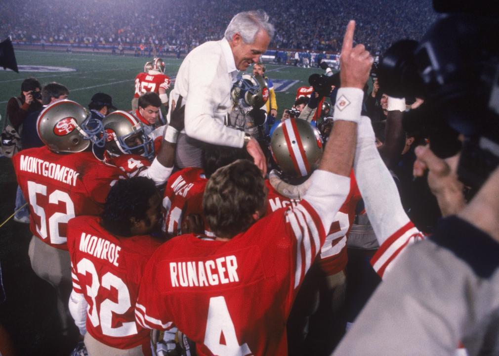 Coach Bill Walsh is held up by his San Francisco 49ers players after defeating the Cincinnati Bengals.