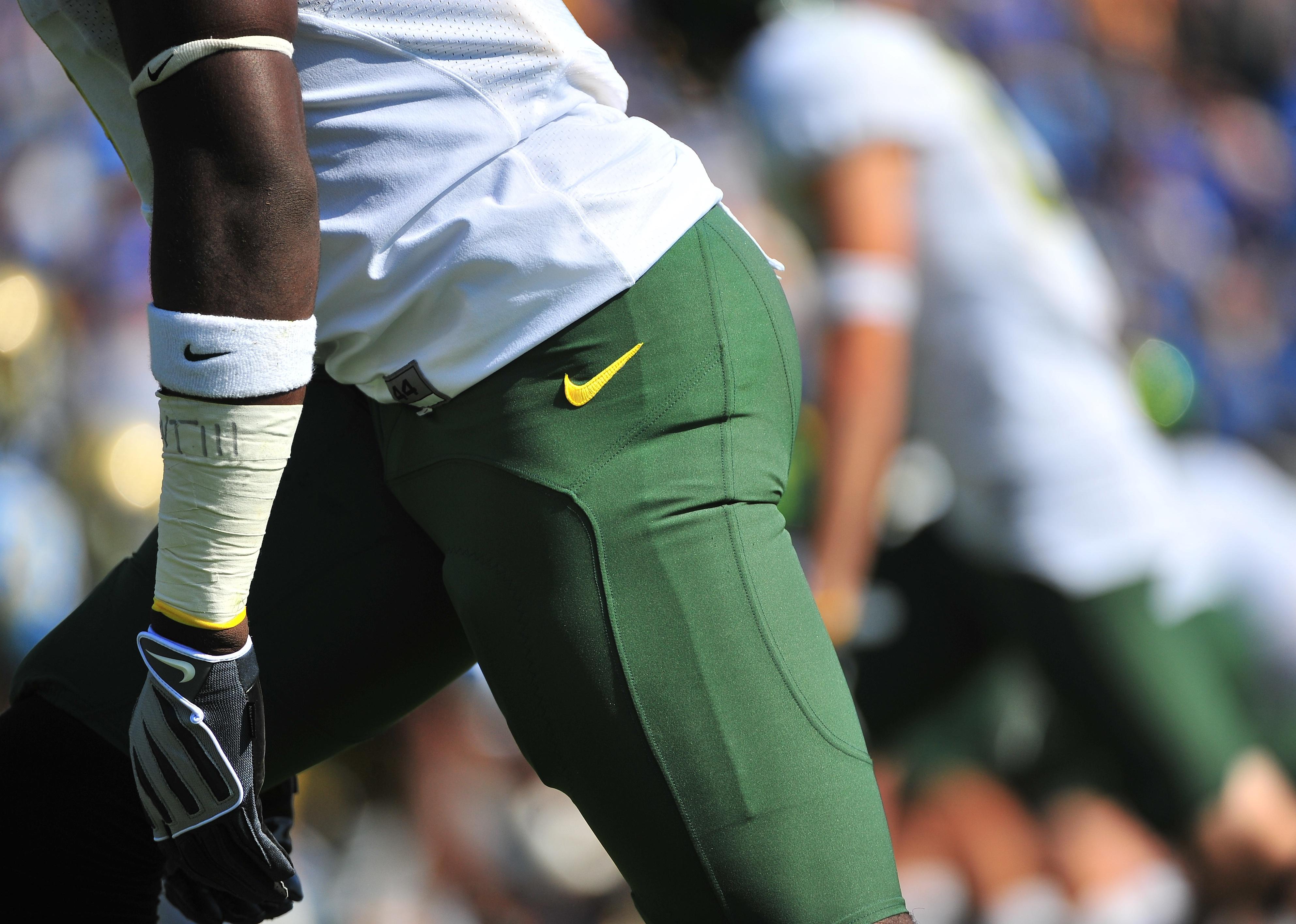  Oregon player detail shot of pants and leg with Nike logos.