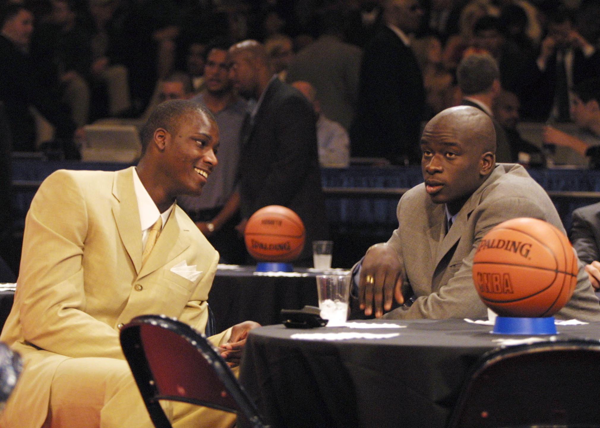 Kwame Brown with Desagana Diop have a conversation during the draft.