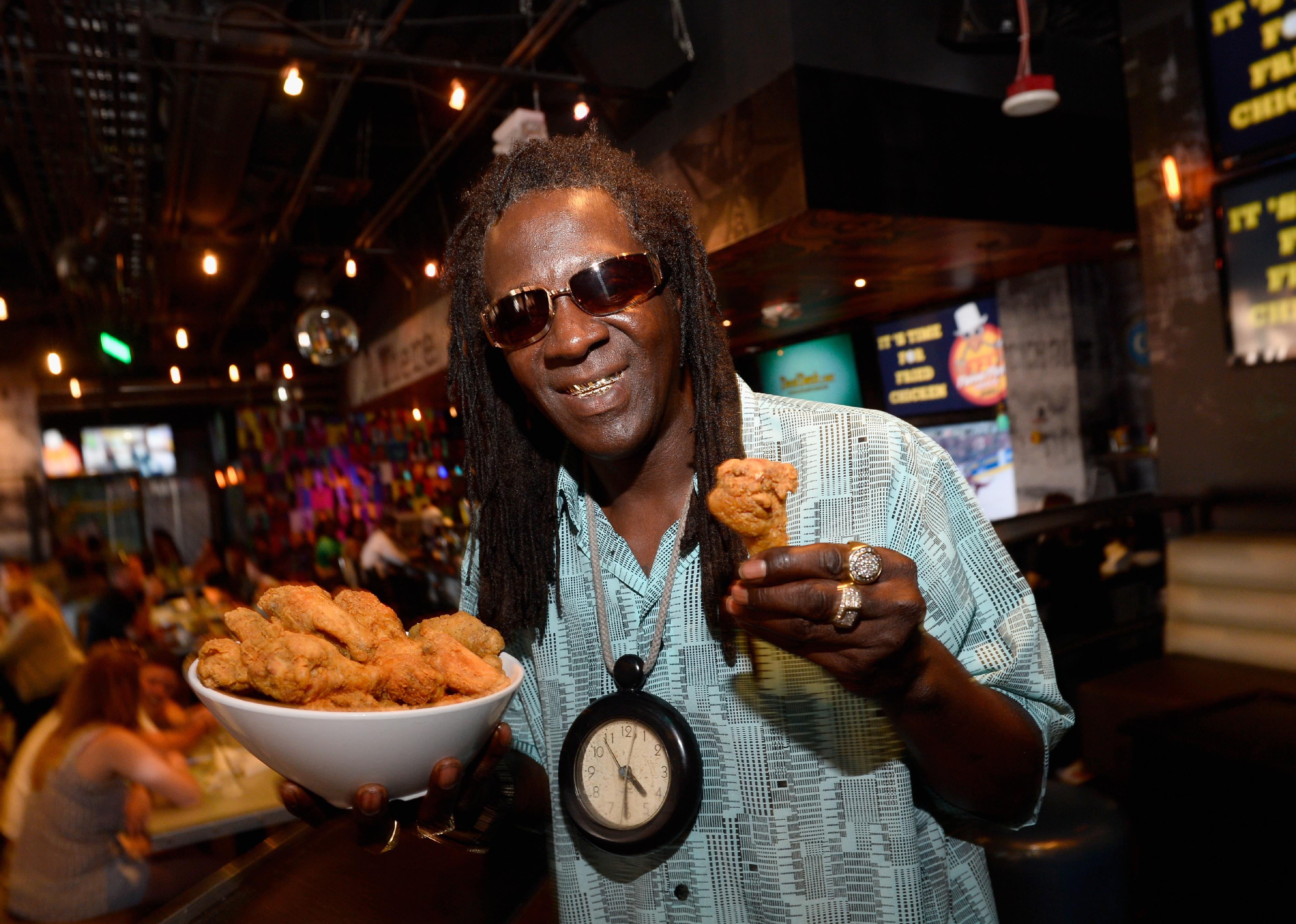 Flavor Flav displays a platter of his signature recipe Flavor Flav's Chicken.