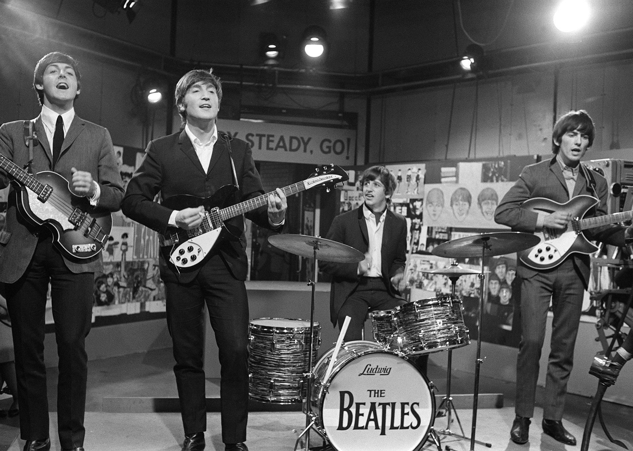 The Beatles performing in a studio.