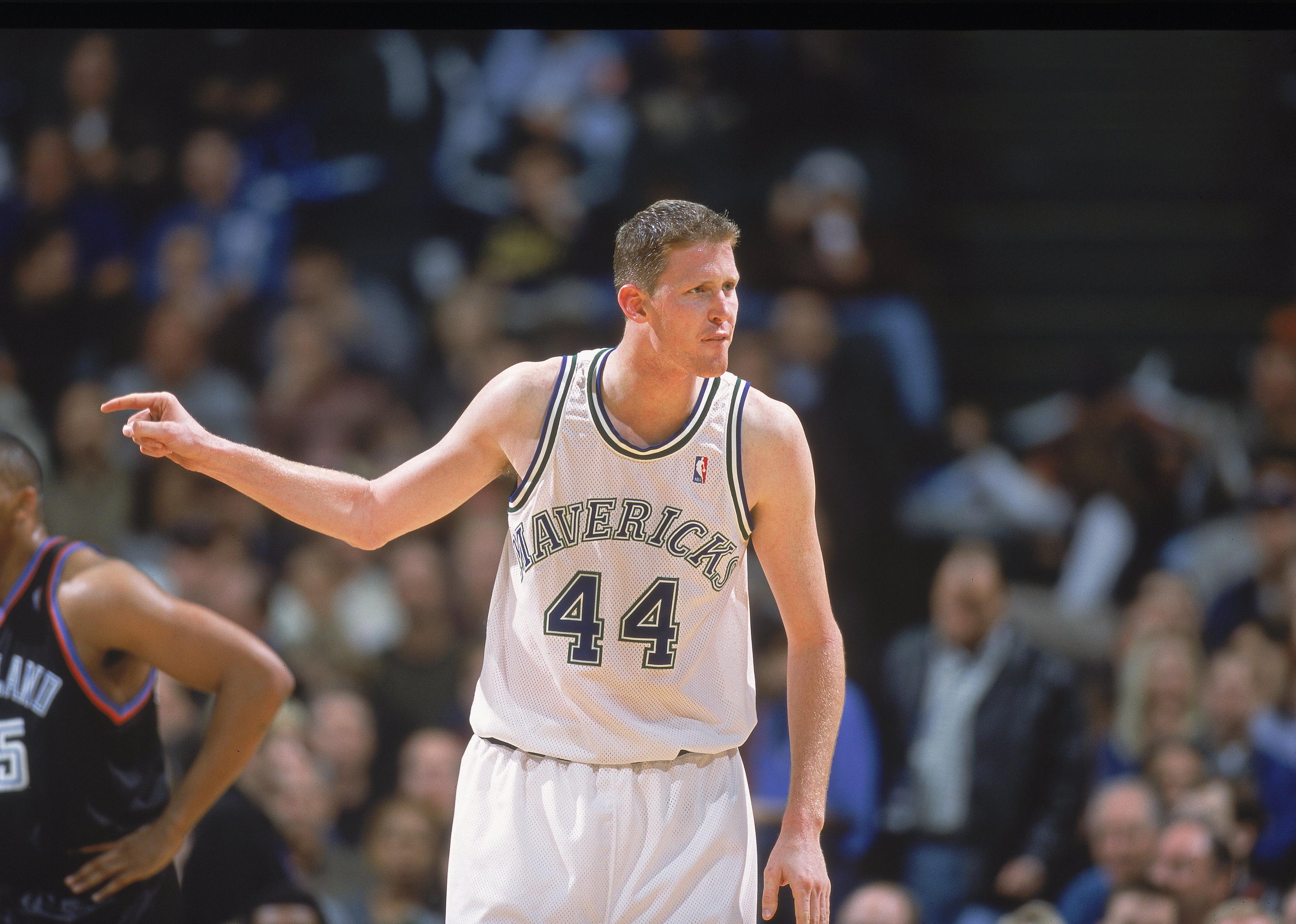 Shawn Bradley points on the court during a game at the Reunion Arena.