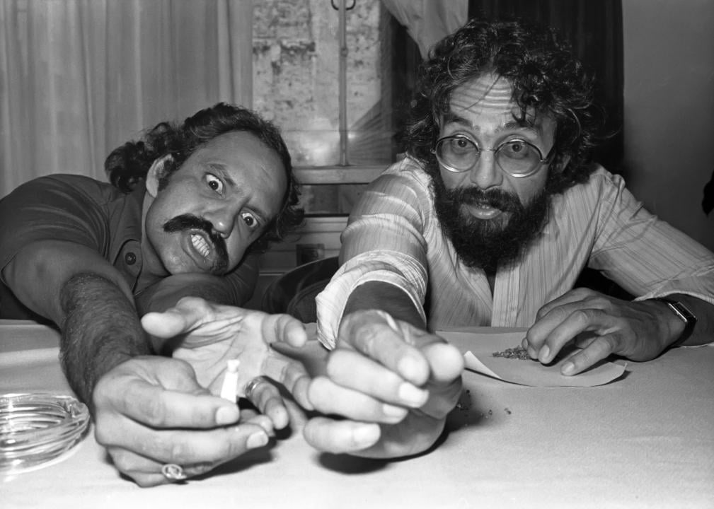 Cheech and Chong with silly faces, sitting in front of ground weed, circa 1978 in New York City. 