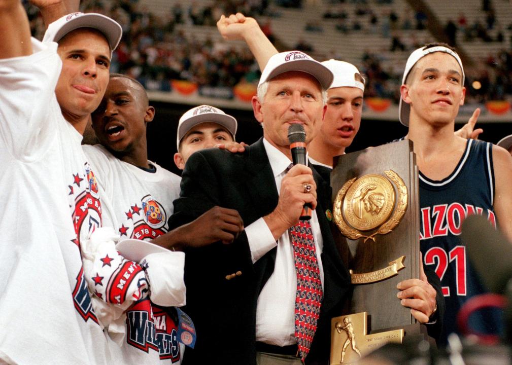 University of Arizona coach Lute Olson addresses the crowd while holding the 1997 NCAA Championship trophy.