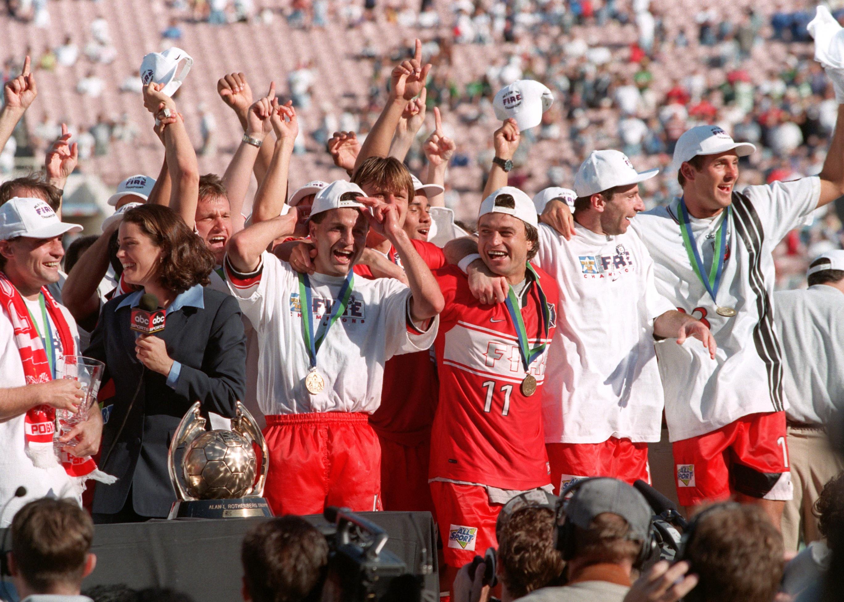 The victorious Chicago Fire team celebrate with the Alan Rothenberg trophy.