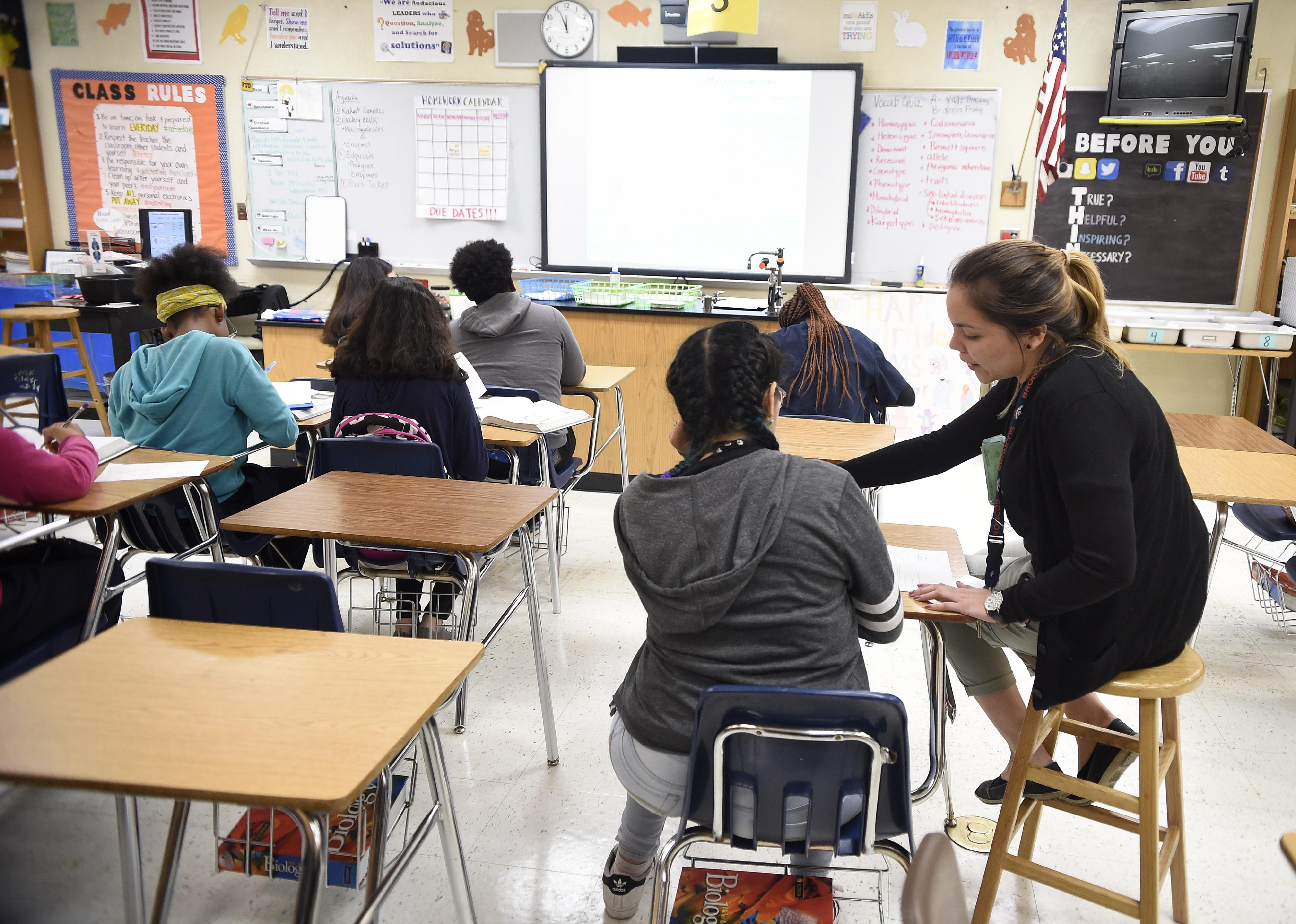 Science teacher Virginia Escobar-Cheng works with her students in a science class