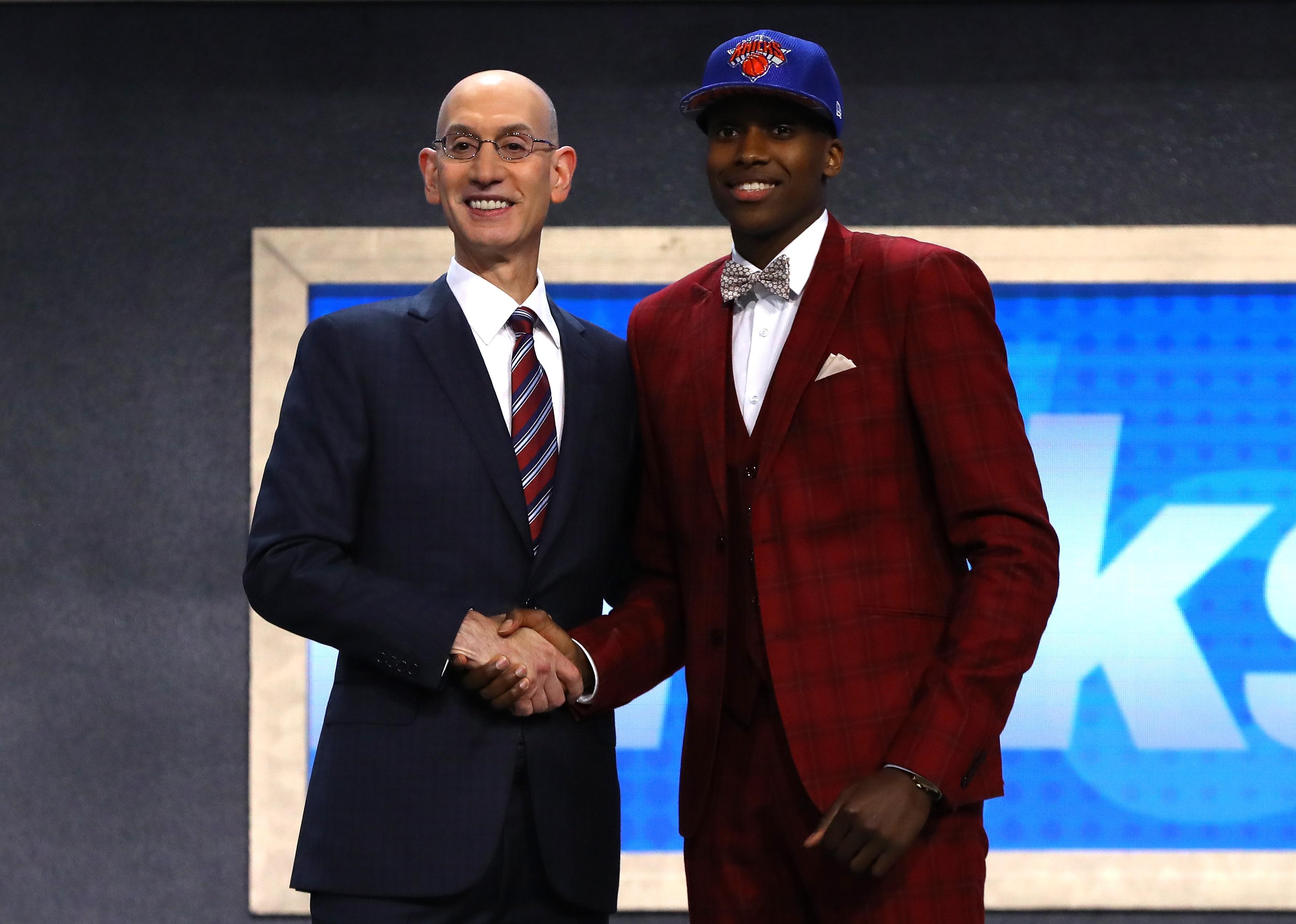 Frank Ntilikina on stage with NBA commissioner Adam Silver after being drafted.
