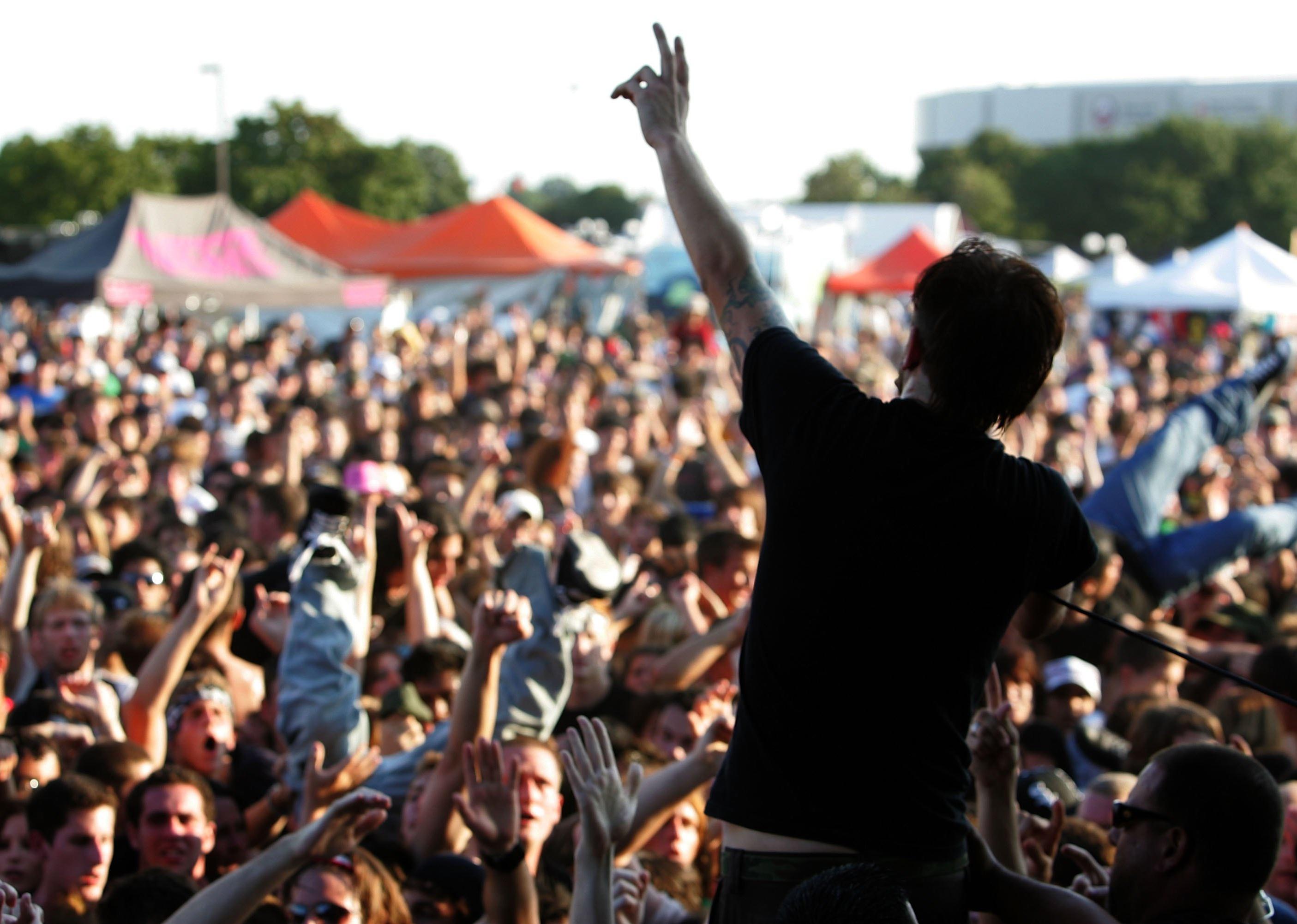 Back view of Tim McIlrath of the band Rise Against performing live onstage at the Vans Warped Tour.