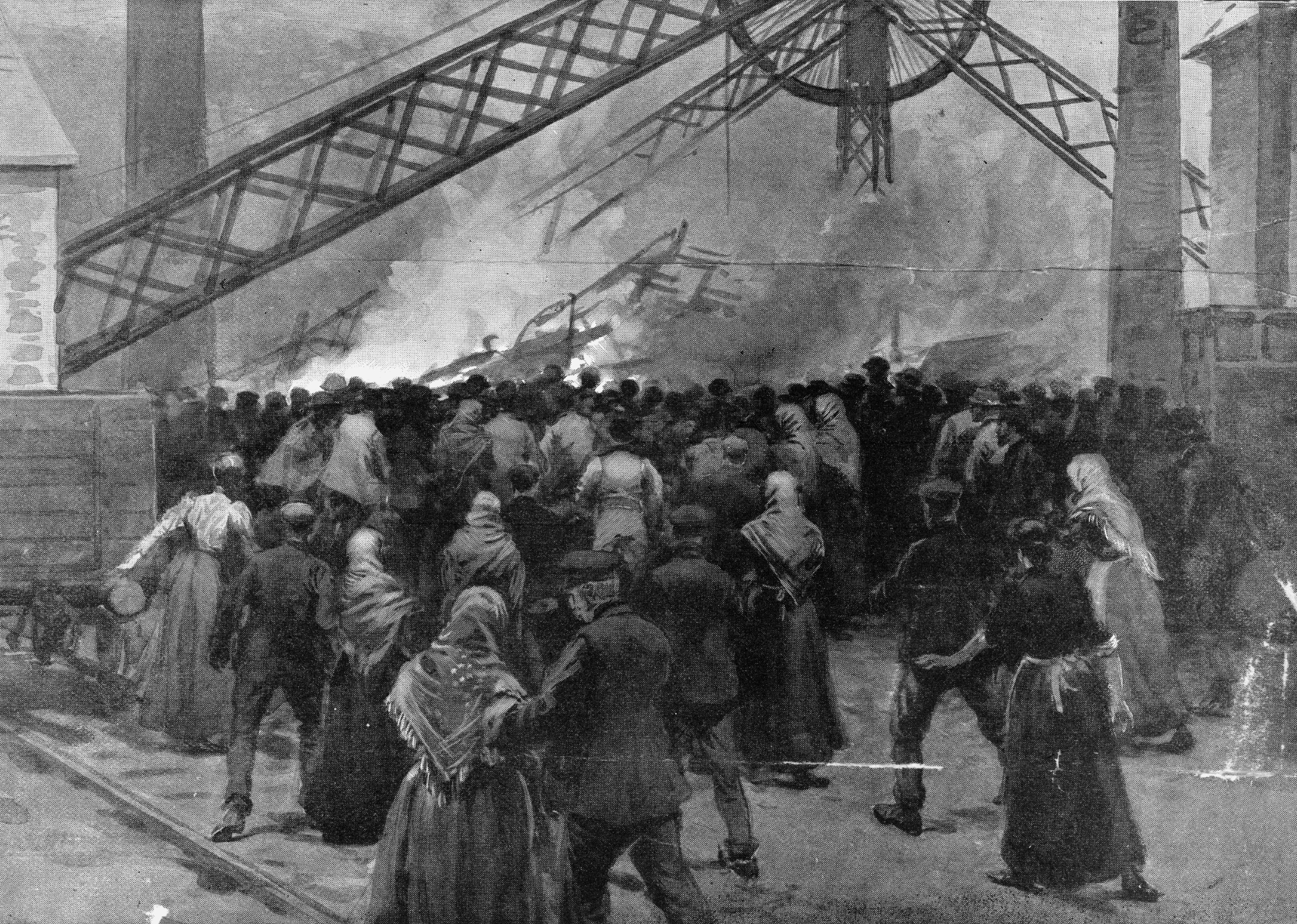 People rush toward the Universal Colliery in Senghenydd.