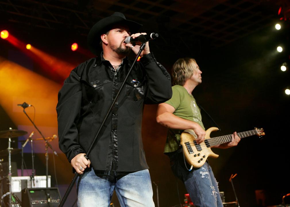 Jason Albert and musician Keith West from the band "Heartland" perform onstage.