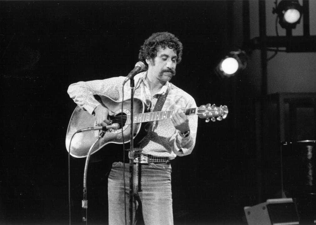 Jim Croce with guitar on stage.