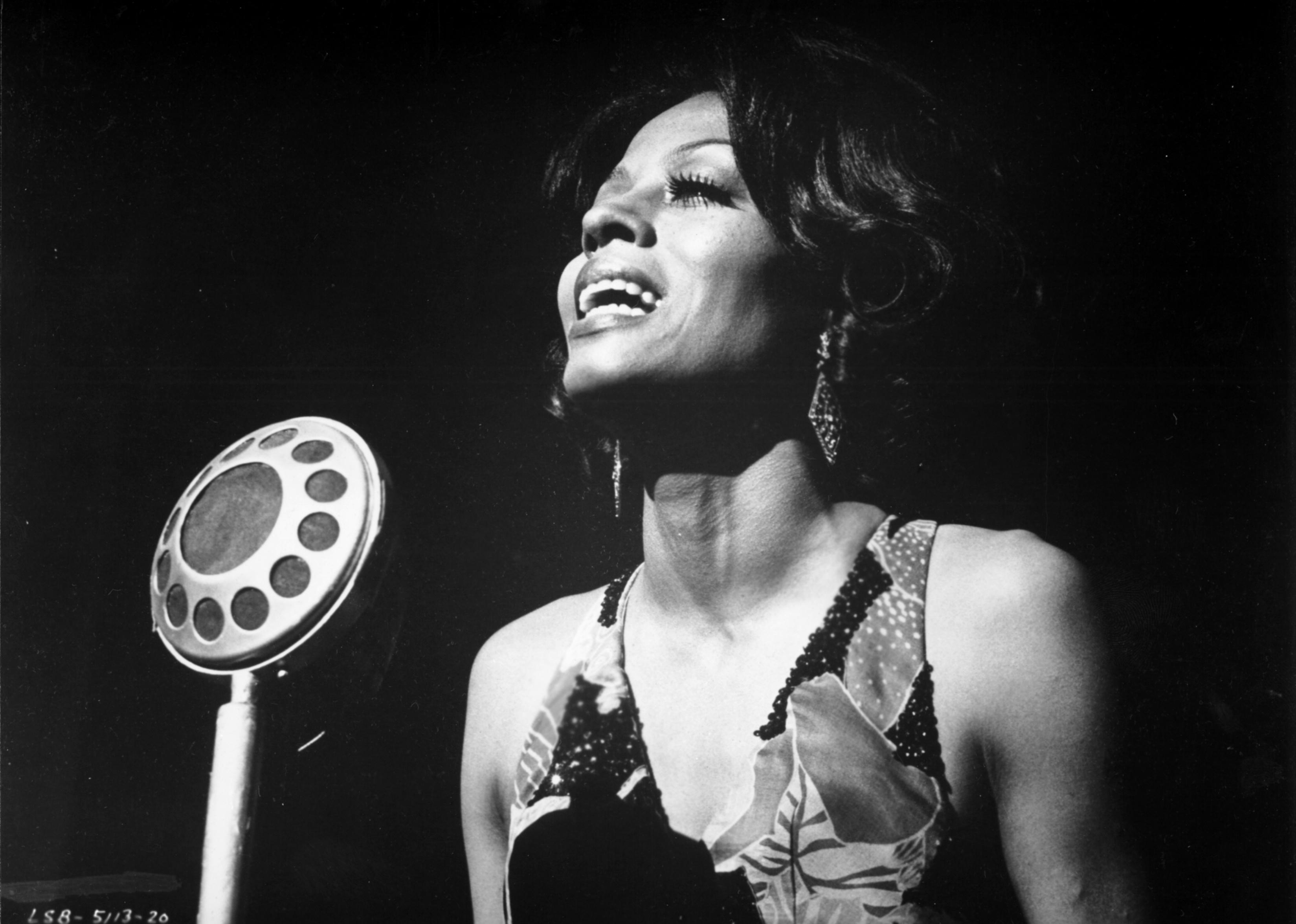 Photo of Diana Ross singing into a mic. 