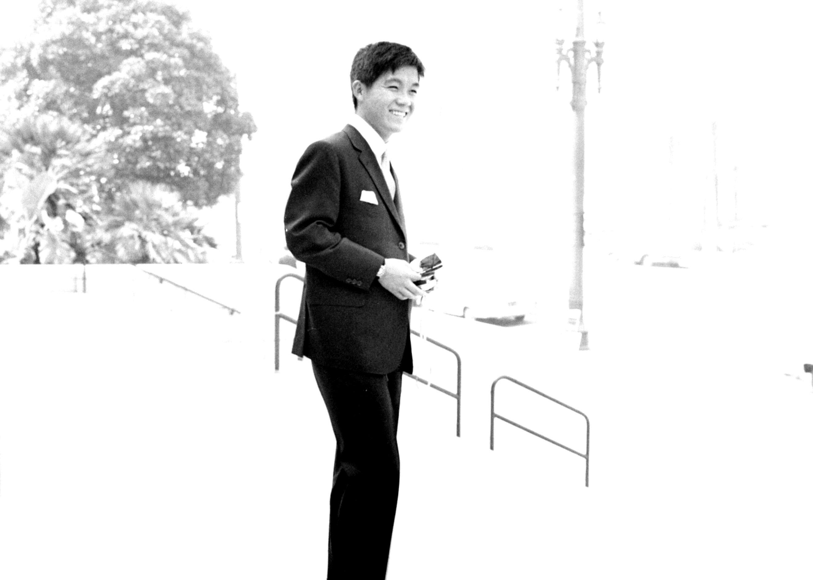Photo of Kyu Sakamoto in a suit.