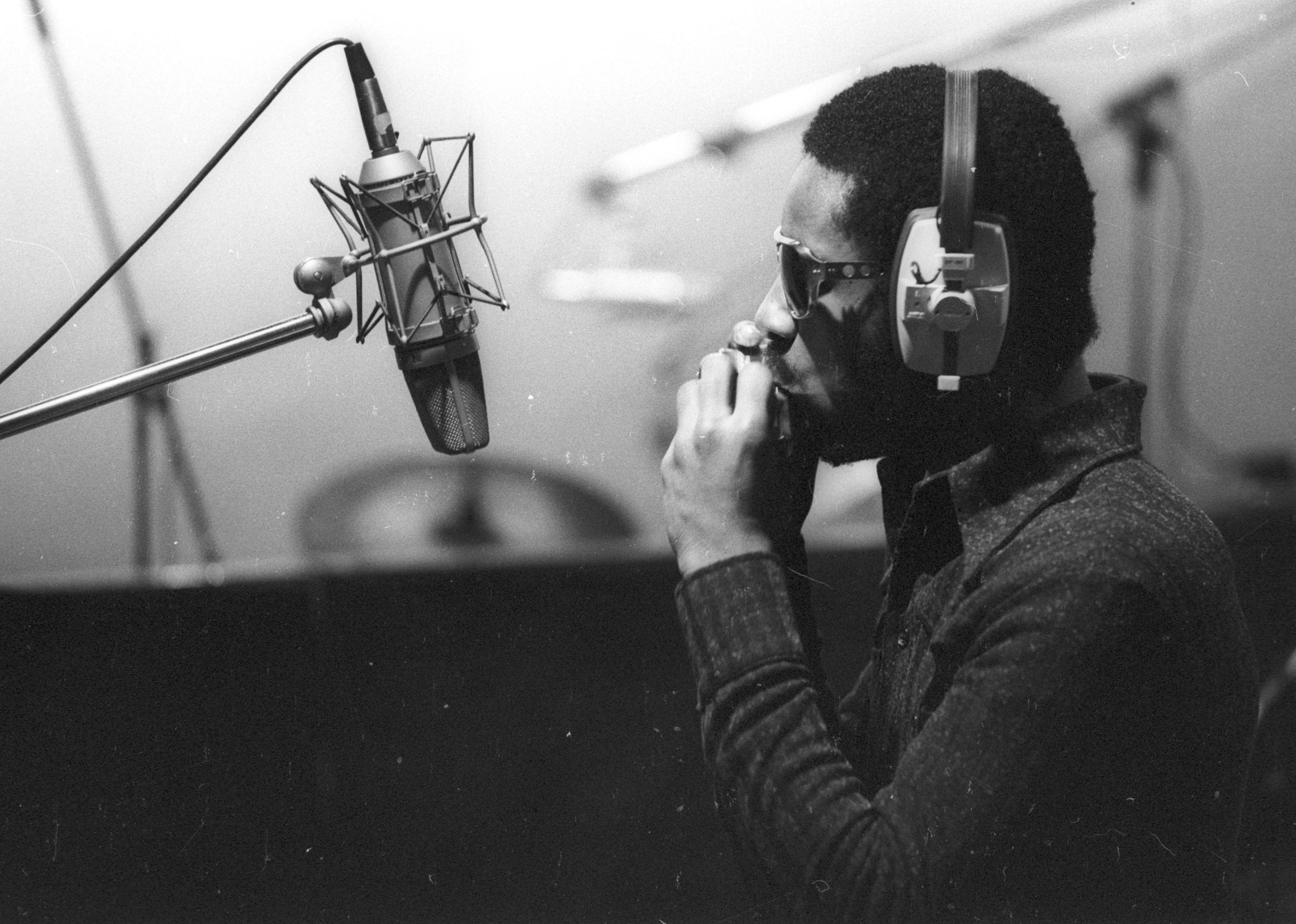 Stevie Wonder recording harmonica in the studio.