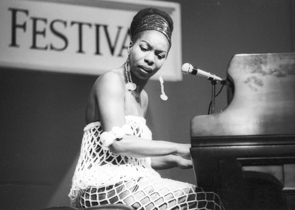Nina Simone performing at the piano.
