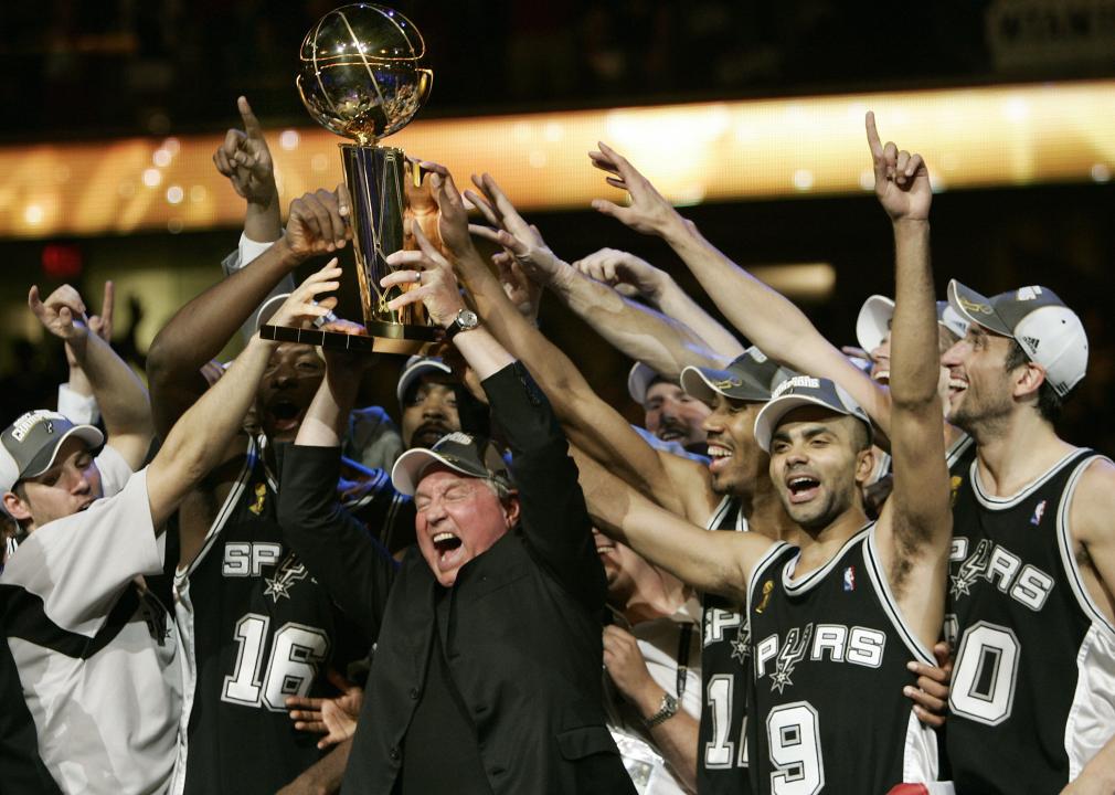 MVP Tony Parker of the San Antonio Spurs celebrates with Spurs' CEO Peter Holt and teammates.