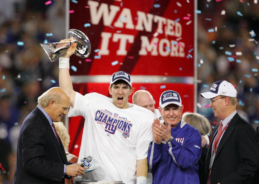 Quarterback Eli Manning of the New York Giants holds the Vince Lombardi Trophy.