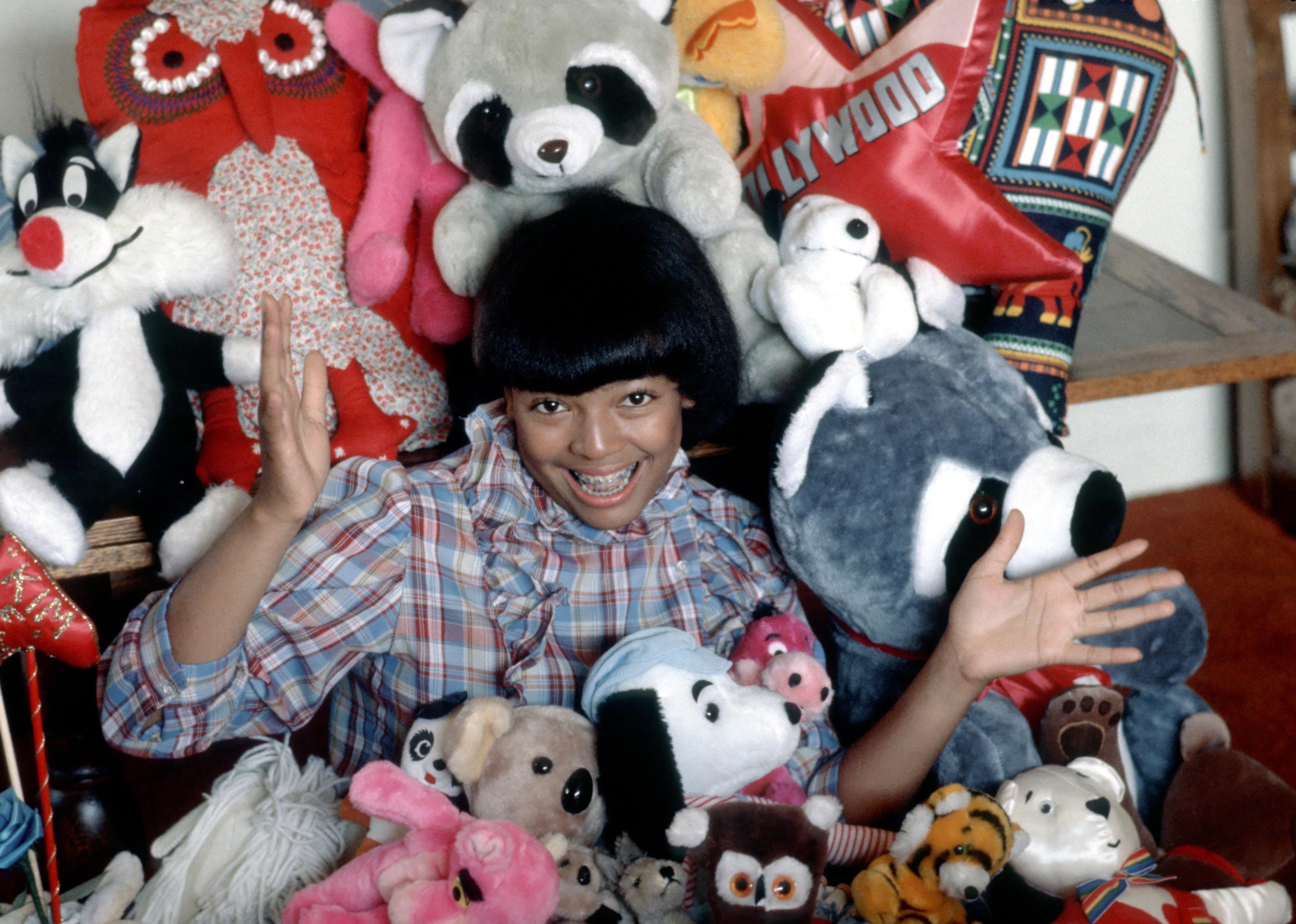 Kim Fields poses with stuffed animals.