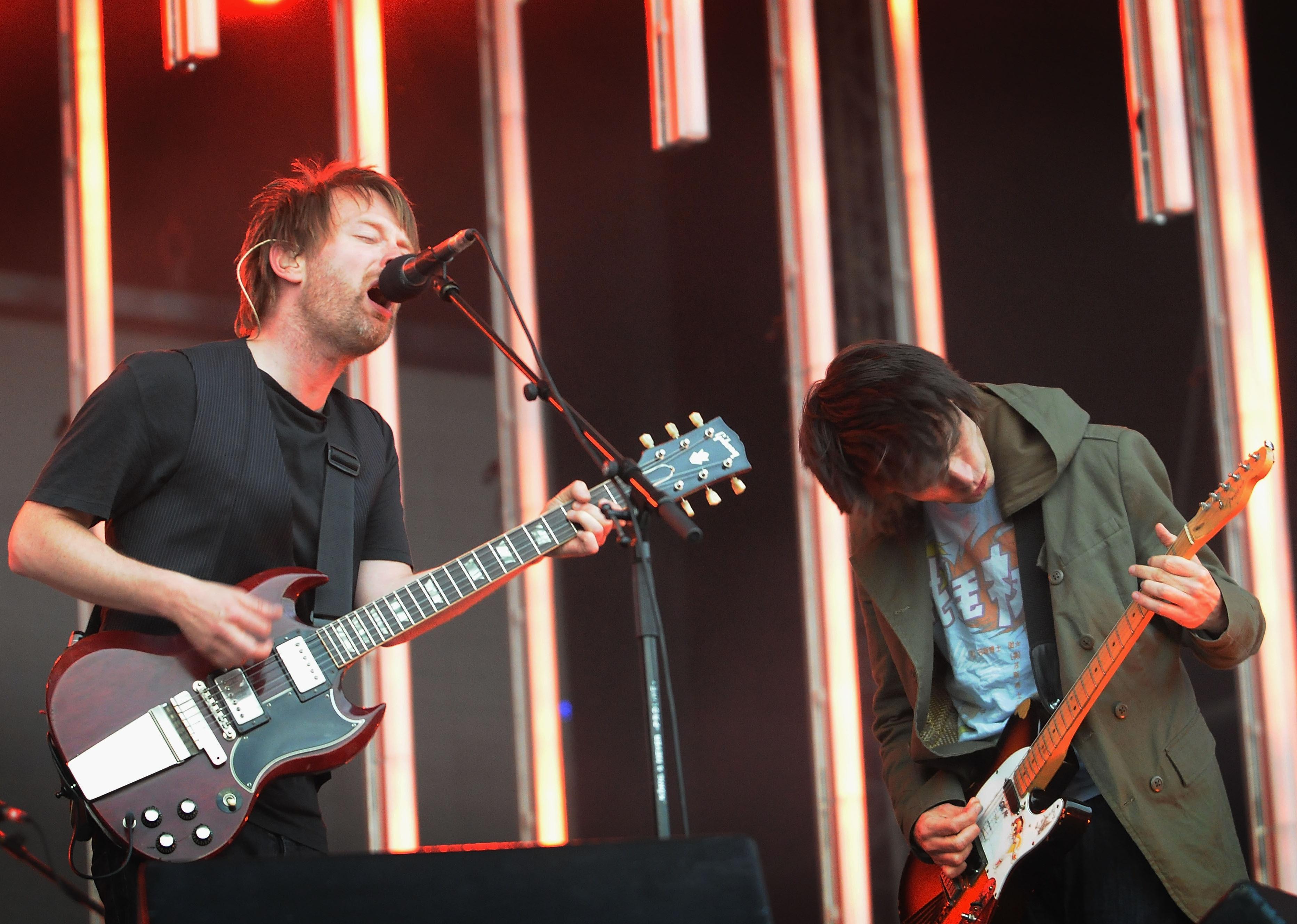 Thom Yorke and Jonny Greenwood of Radiohead perform on stage.