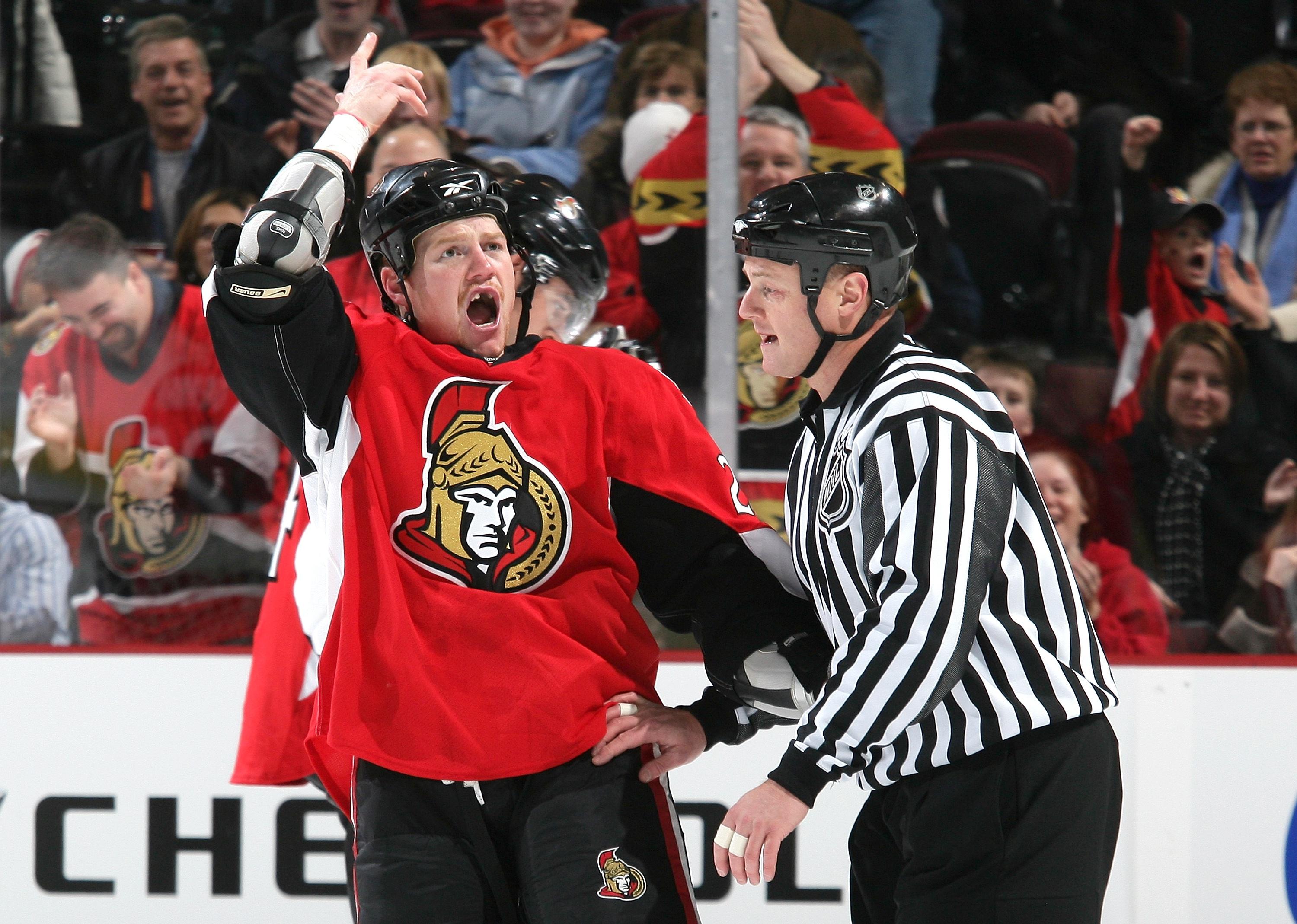 Chris Neil gestures to pump up the crowd after a fight.