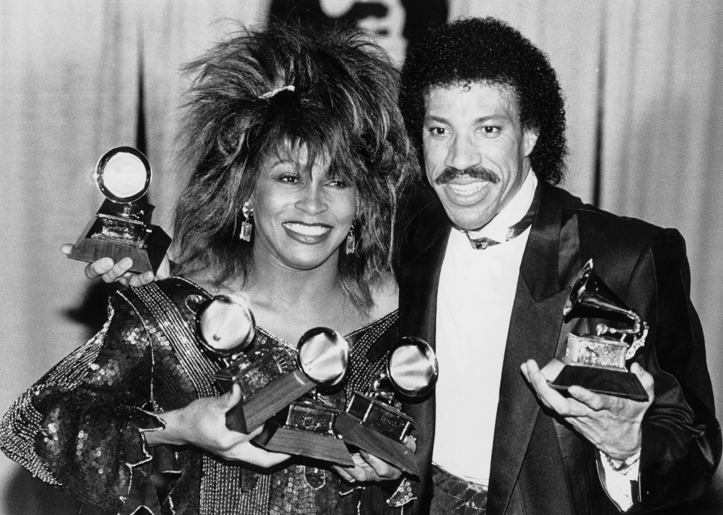 Tina Turner at the 1985 Grammy Awards with Lionel Richie and his award.