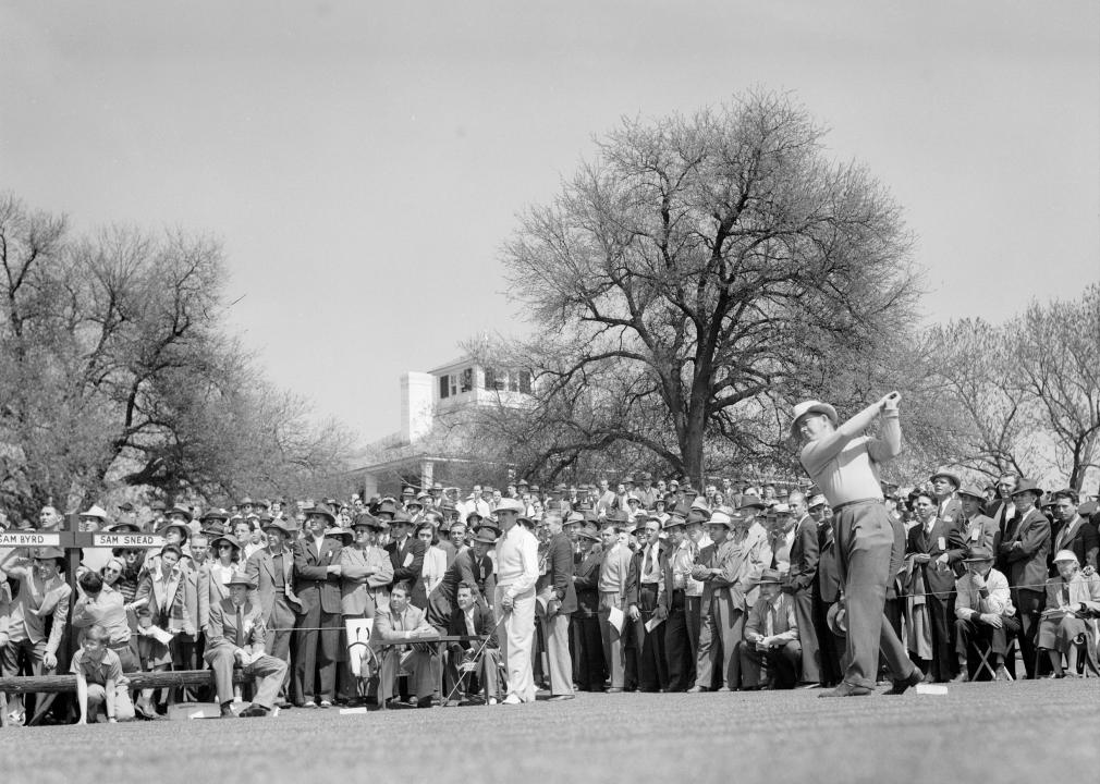 Sam Byrd tees off as Sam Snead watches