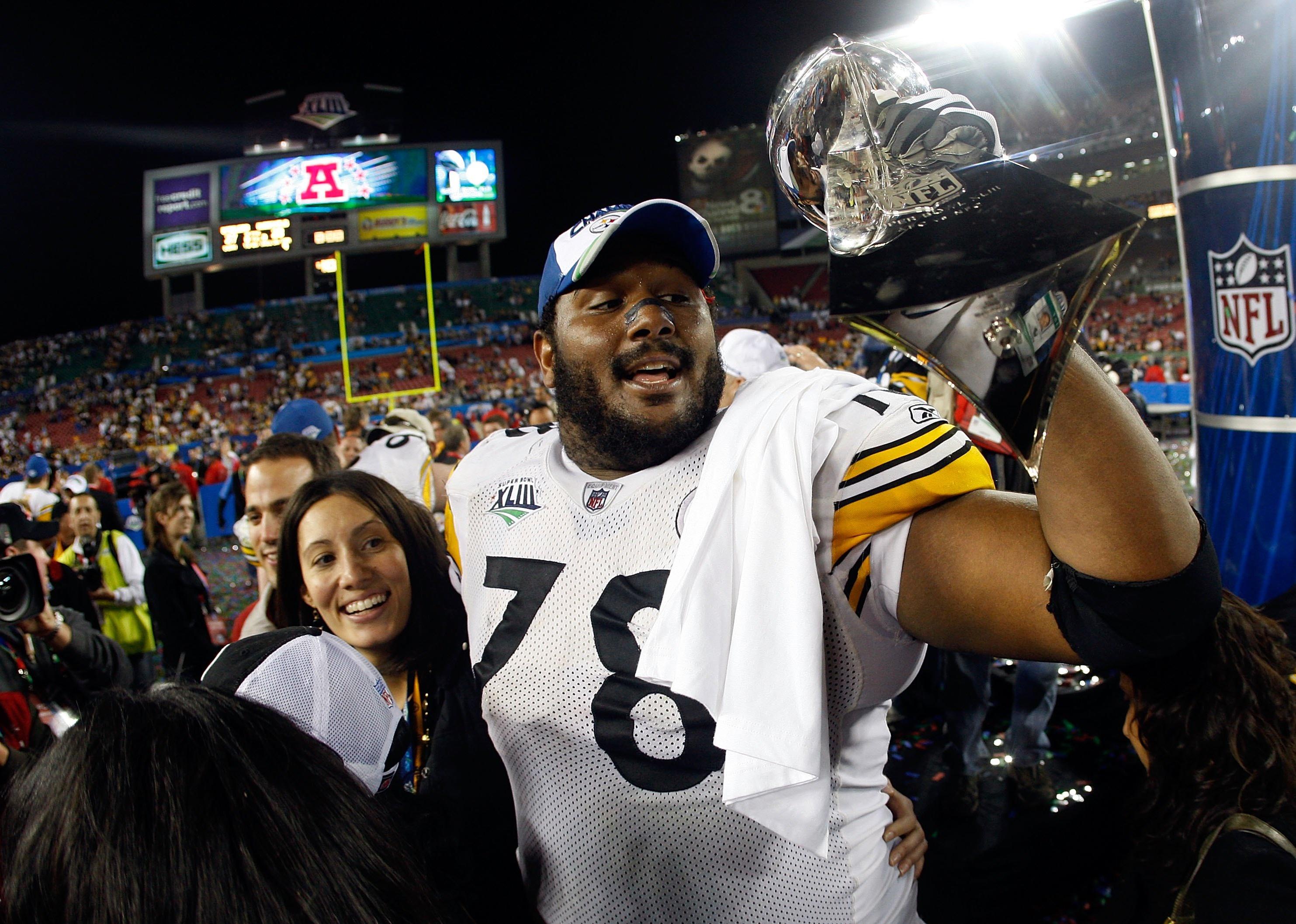 Max Starks of the Pittsburgh Steelers holds up the Vince Lombardi Trophy.