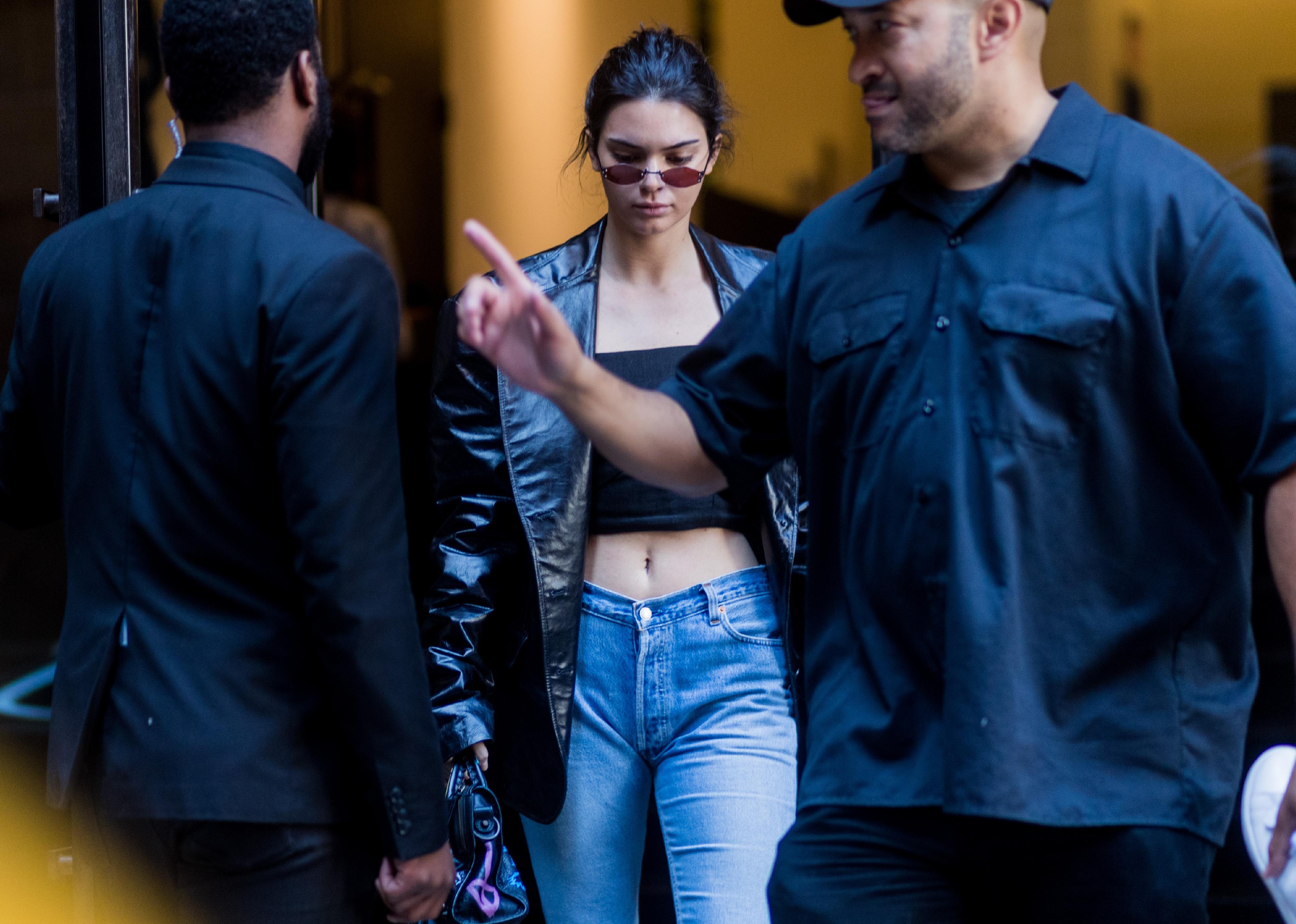 Kendall Jenner wearing cropped top, denim jeans, black jacket seen in the streets of Manhattan.