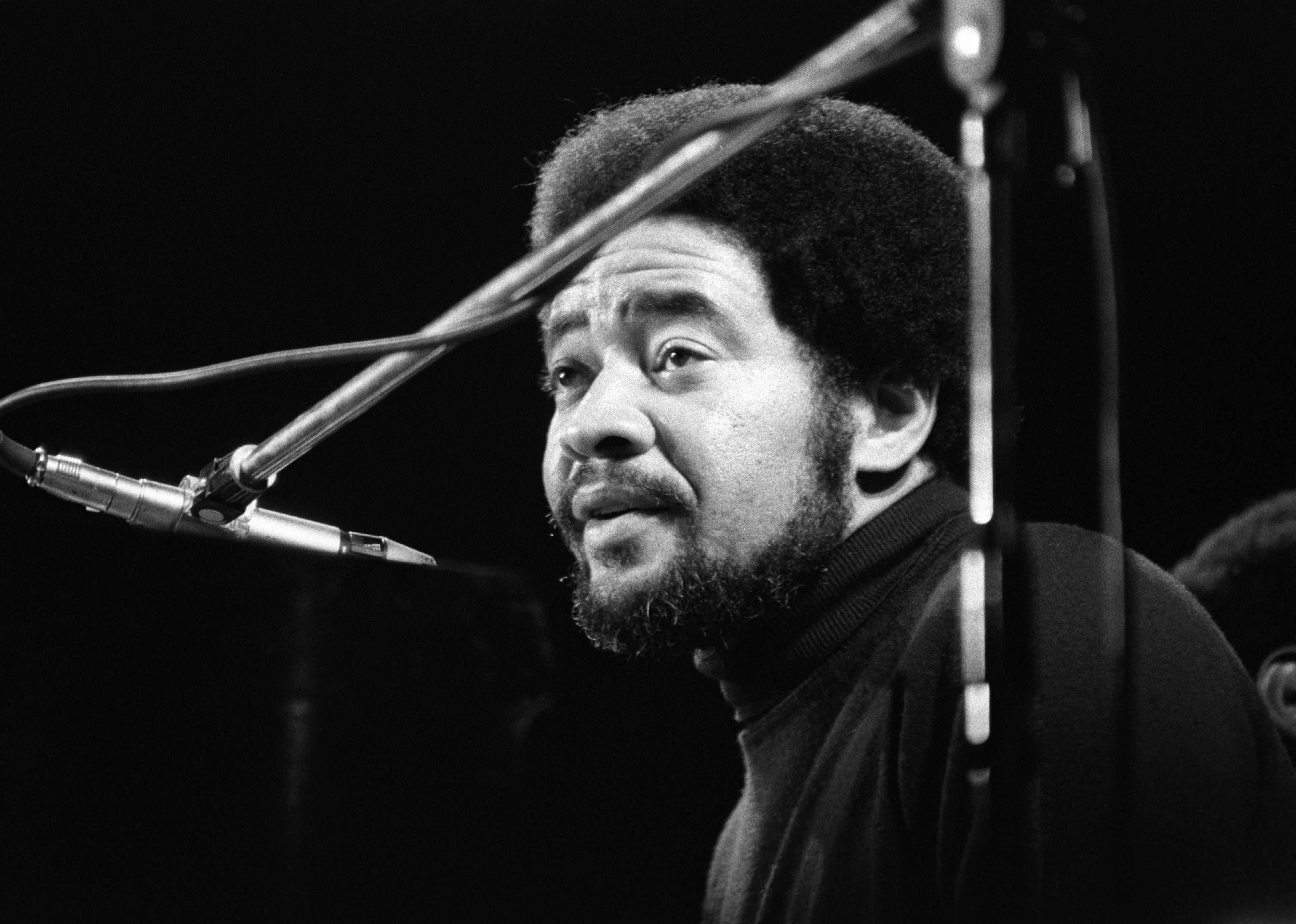 Bill Withers performs on stage at the Rainbow Theatre.