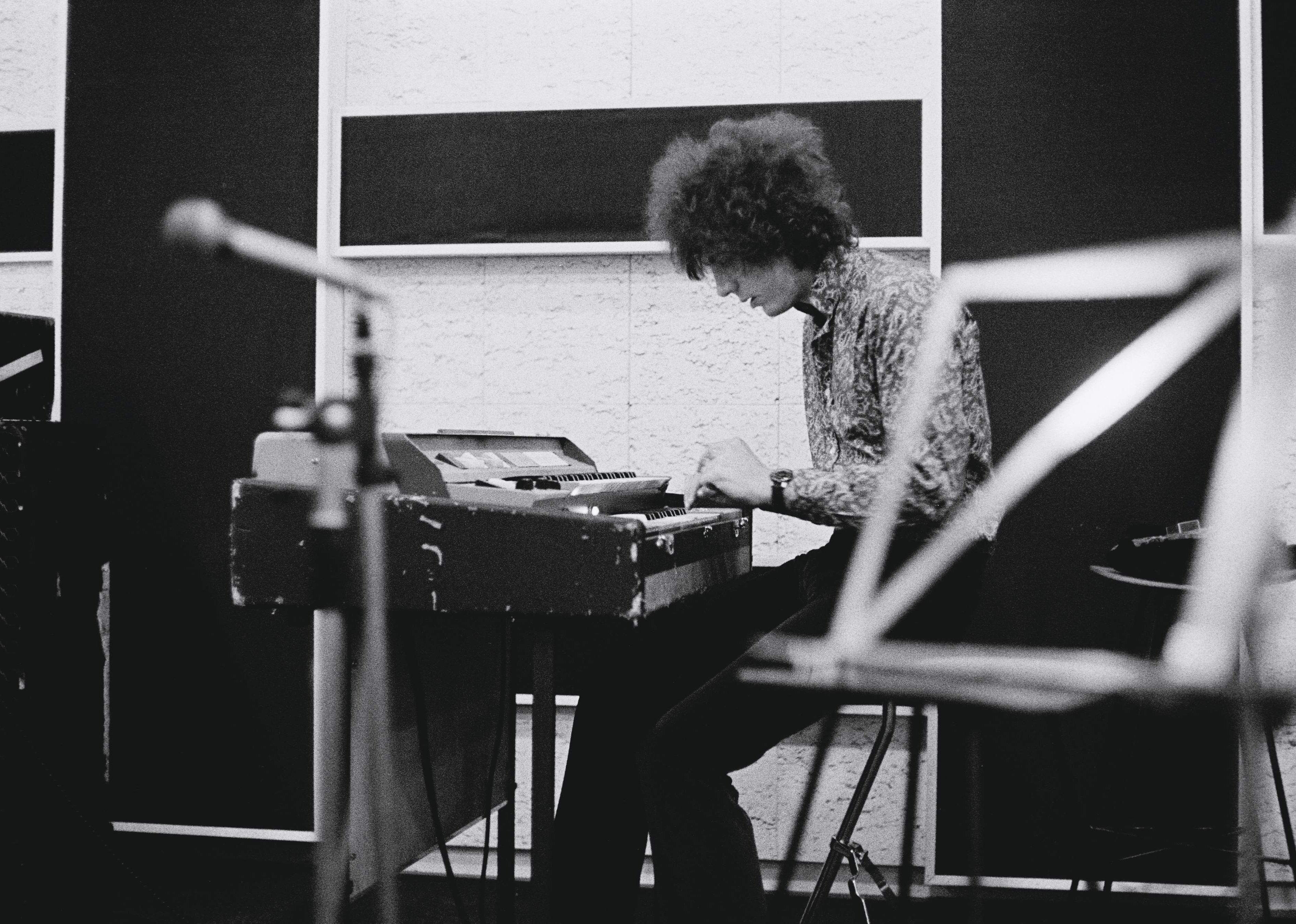 Syd Barrett playing keyboards in a recording studio.