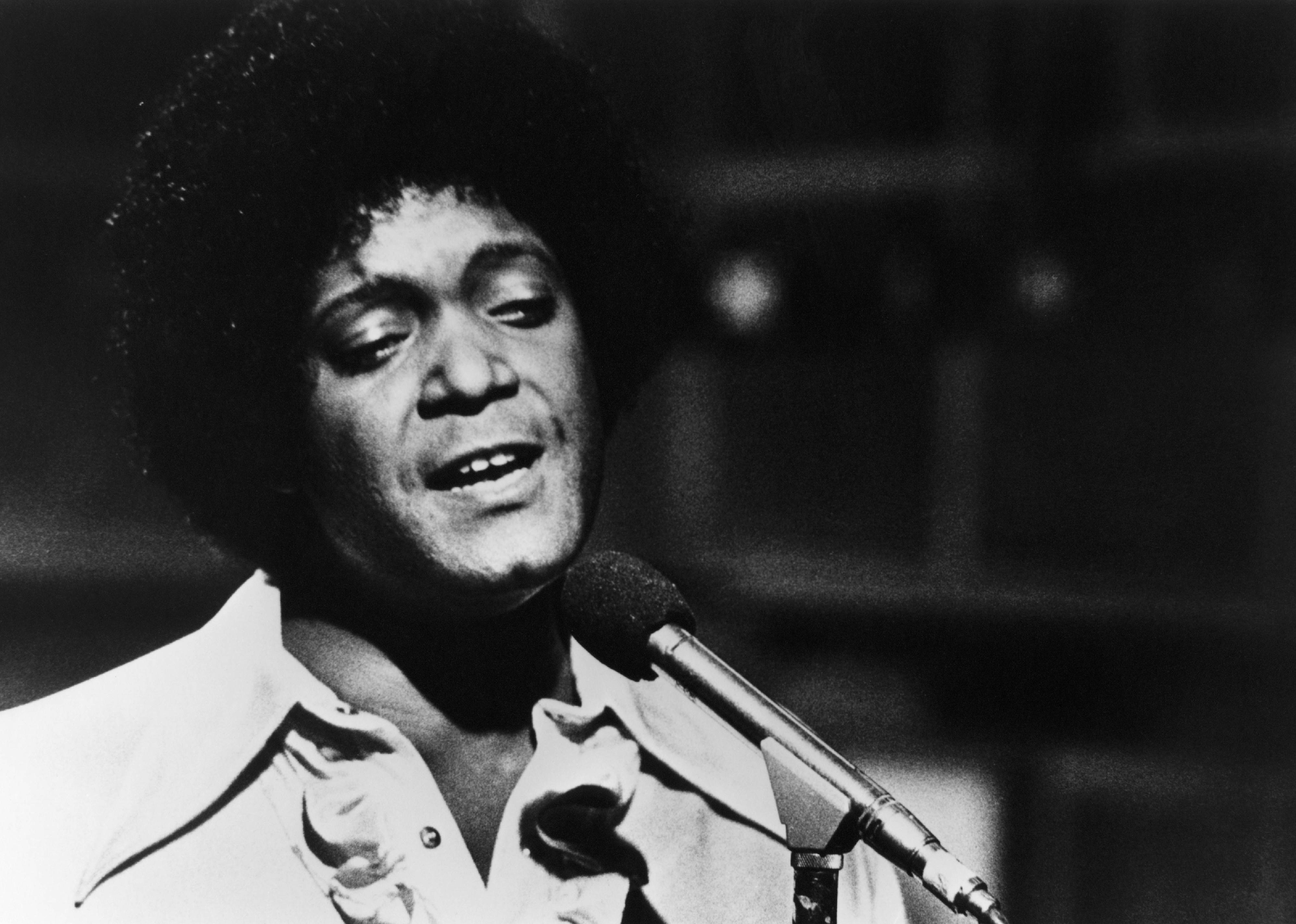 Dobie Gray performing on stage.