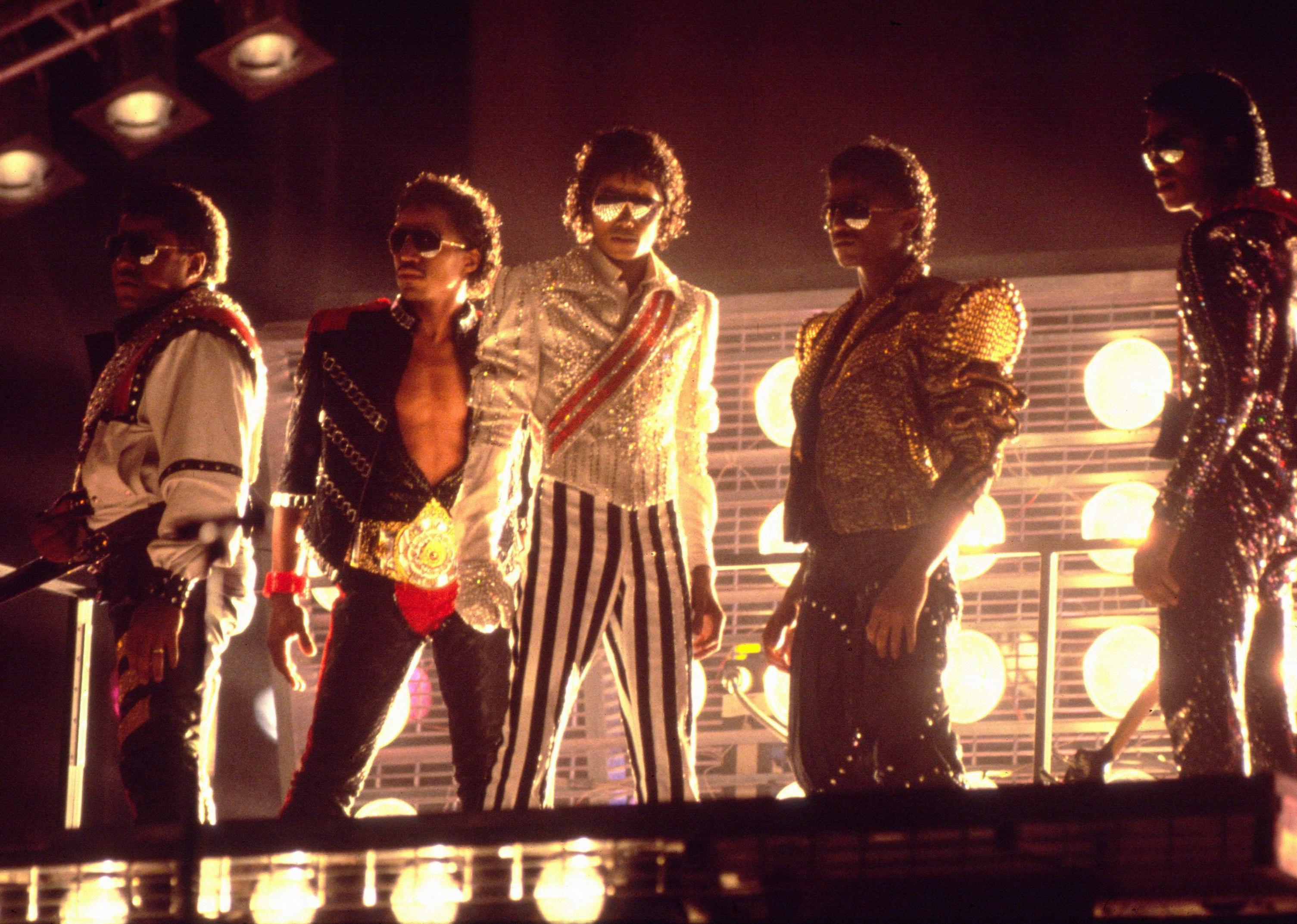 Tito, Marlon, Michael, Randy and Jermaine Jackson performing on stage.