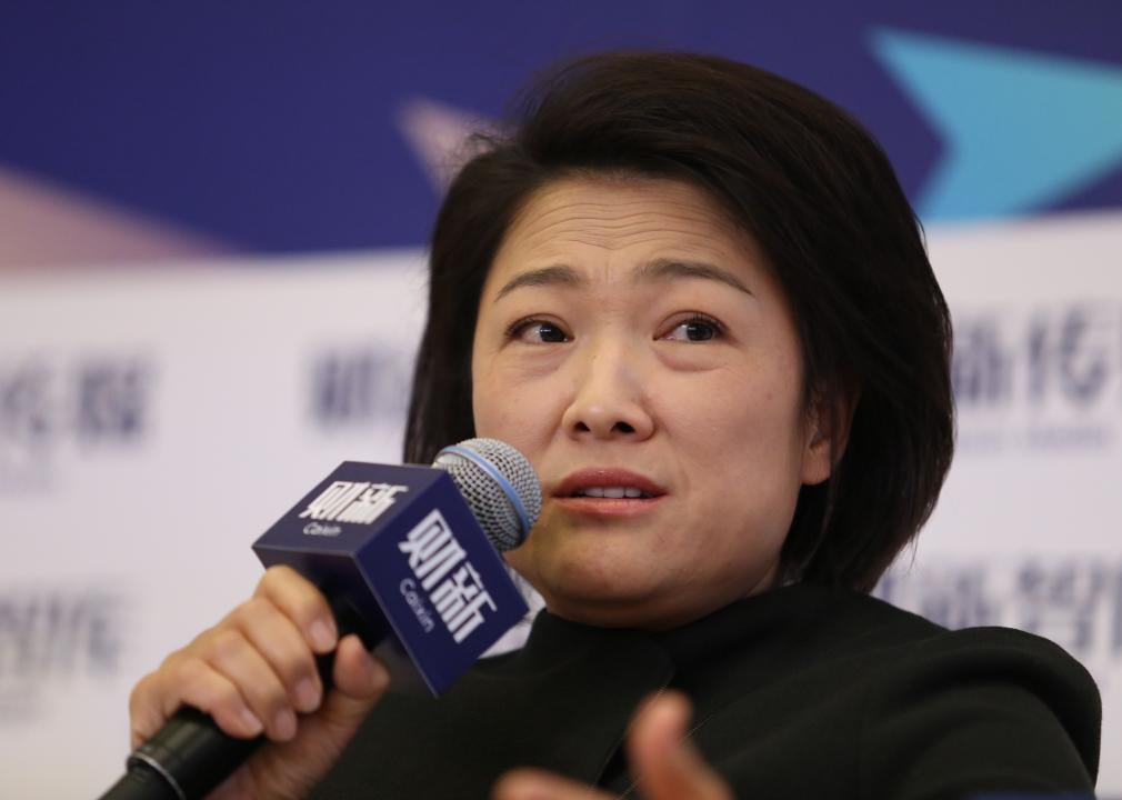 Zhang Xin speaks into a microphone