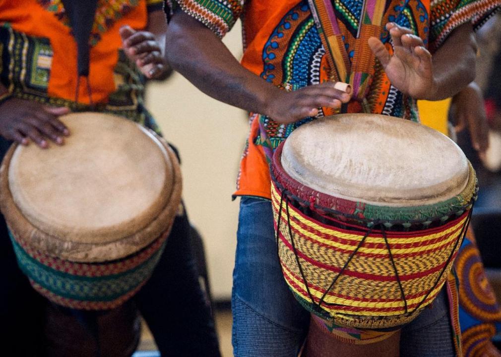A close up of two people drumming.