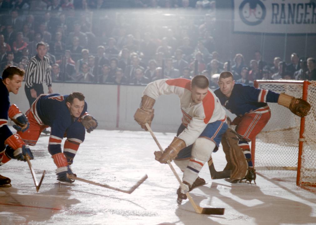 Jean-Guy Talbot skates with the puck as other players defend