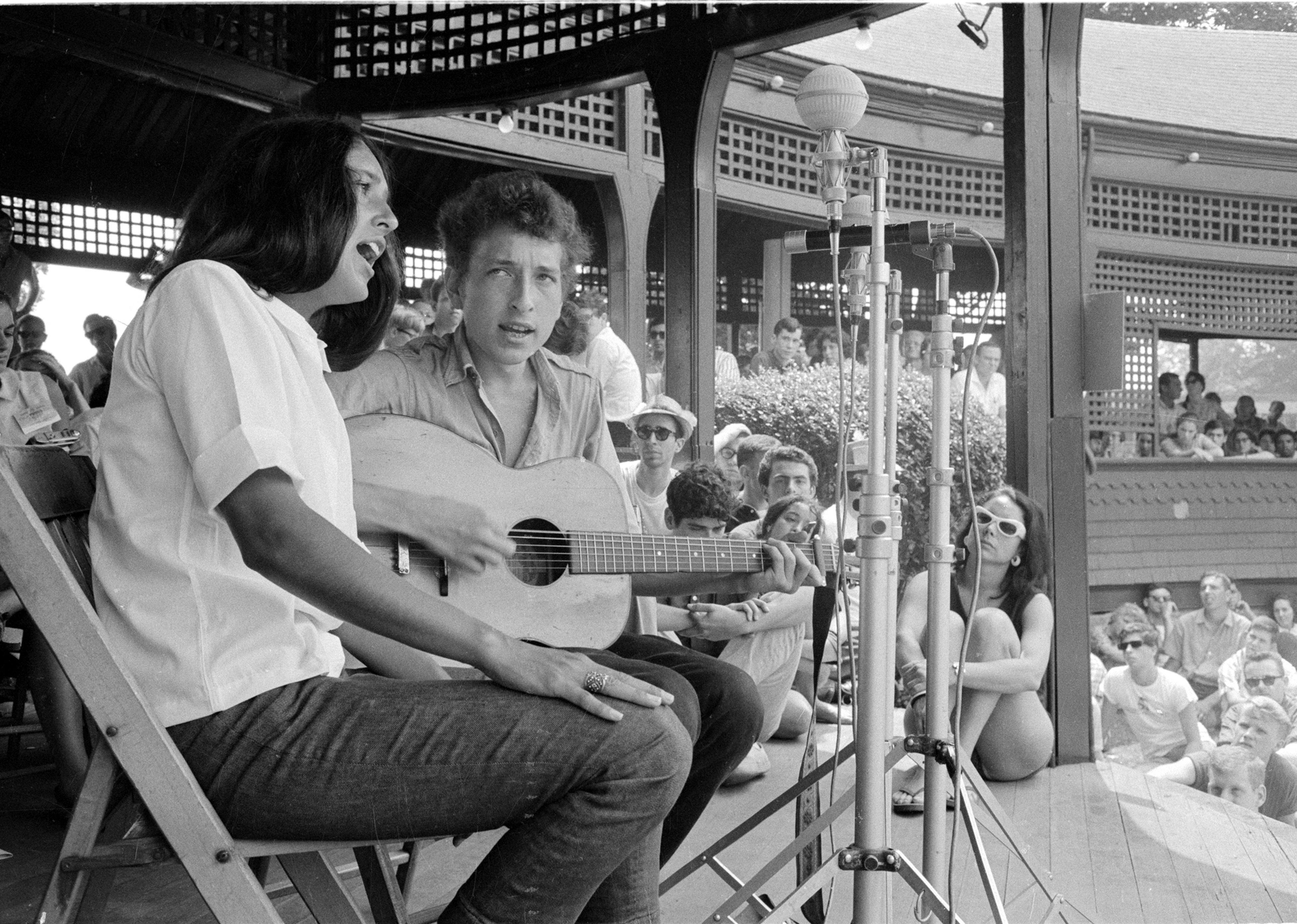 Joan Baez and Bob Dylan on stage during a duet at the Newport Folk Festival.