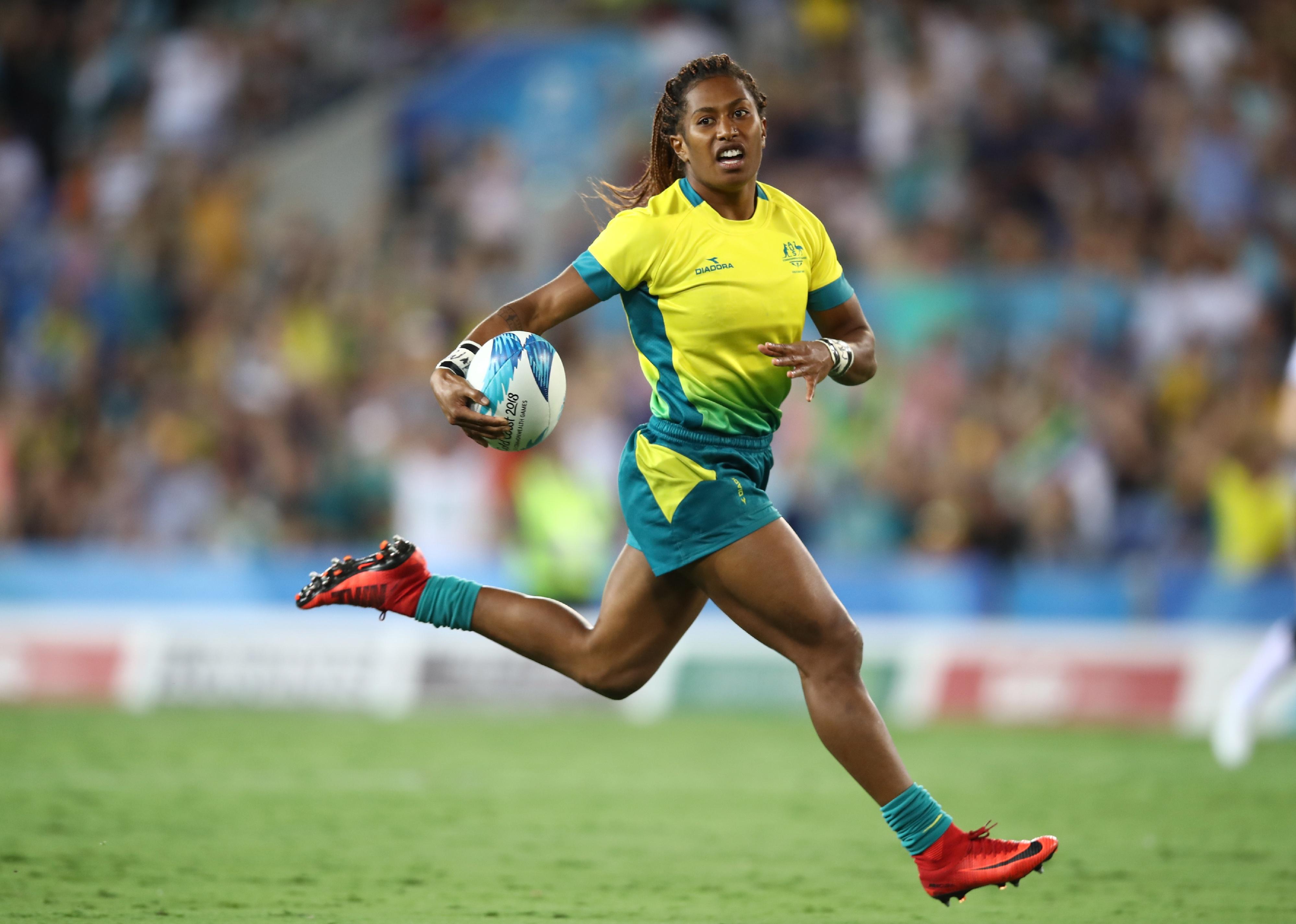 Ellia Green of Australia runs in for a try in a match.